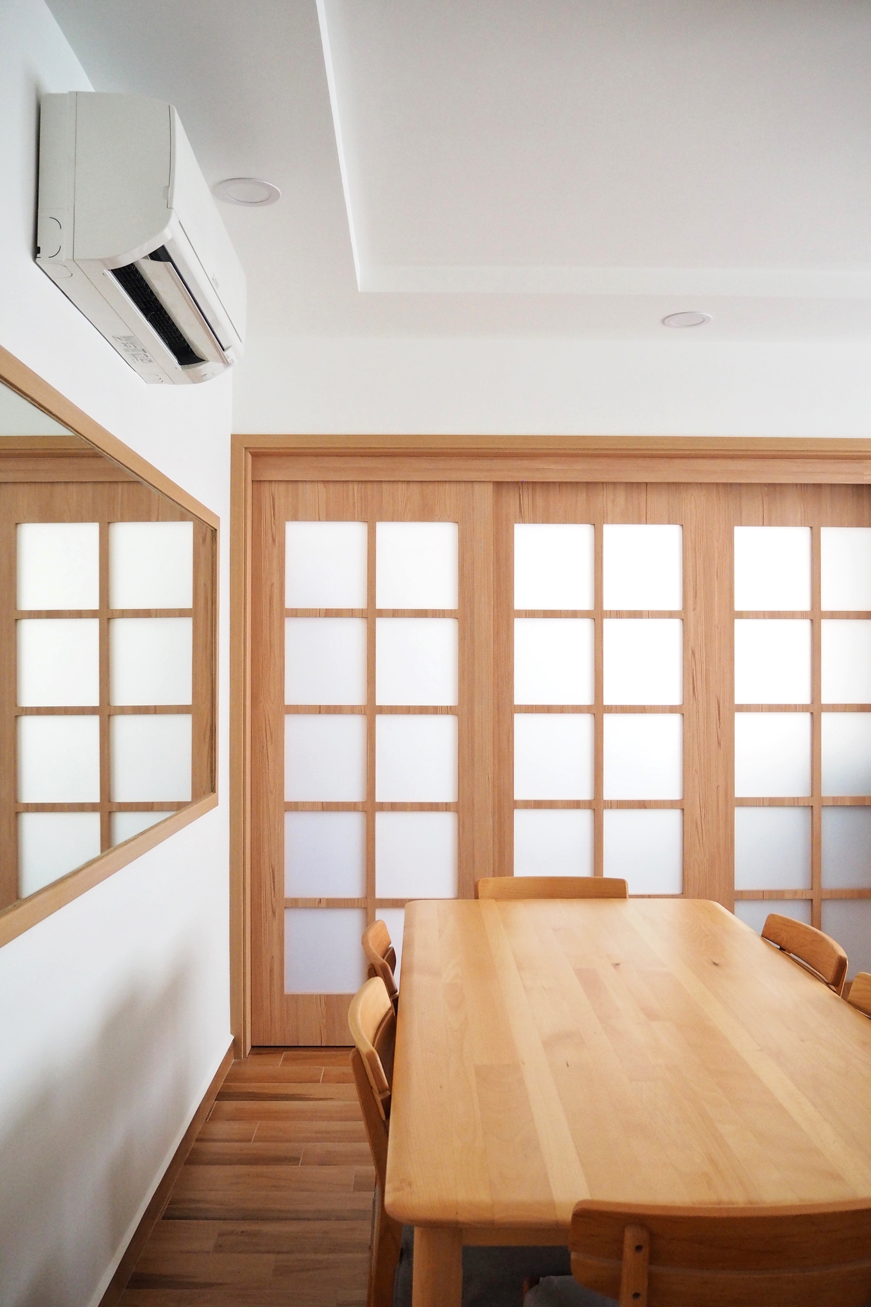 Our Serene Dining Space - Wooden dining table, minimalist design, wooden chairs, room with natural light, white ceiling, air