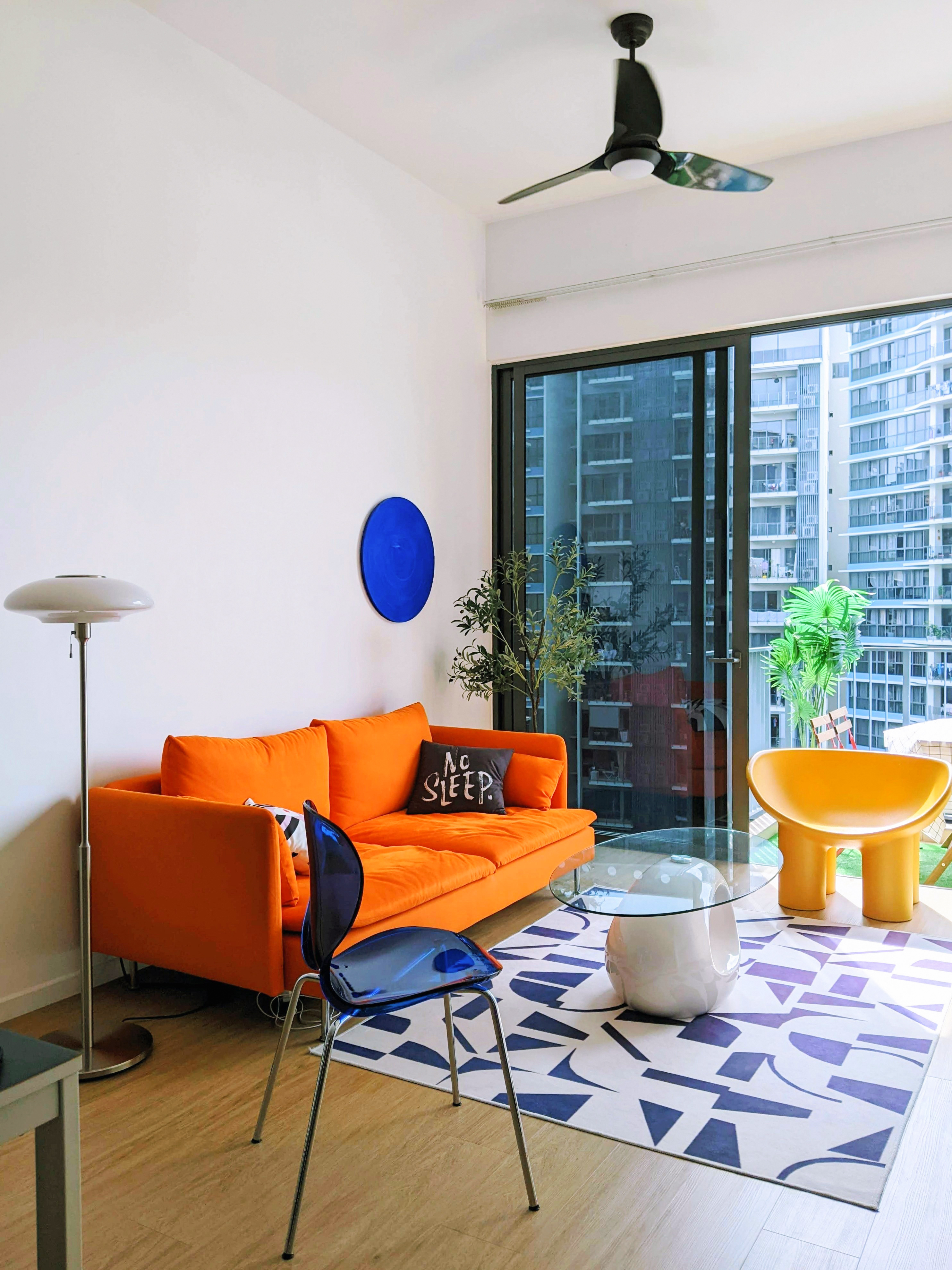 Vibrant Living Room With An Orange Sofa & Yellow Elephant Leg Chair - Modern living room with vibrant orange sofa, blue and