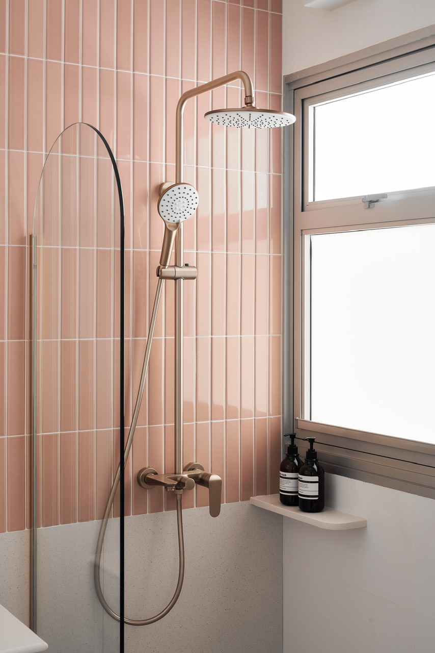 Dream Pink Bathroom without overlaying all walls - Pink-tiled bathroom, modern shower, gold fixtures, frosted glass shower