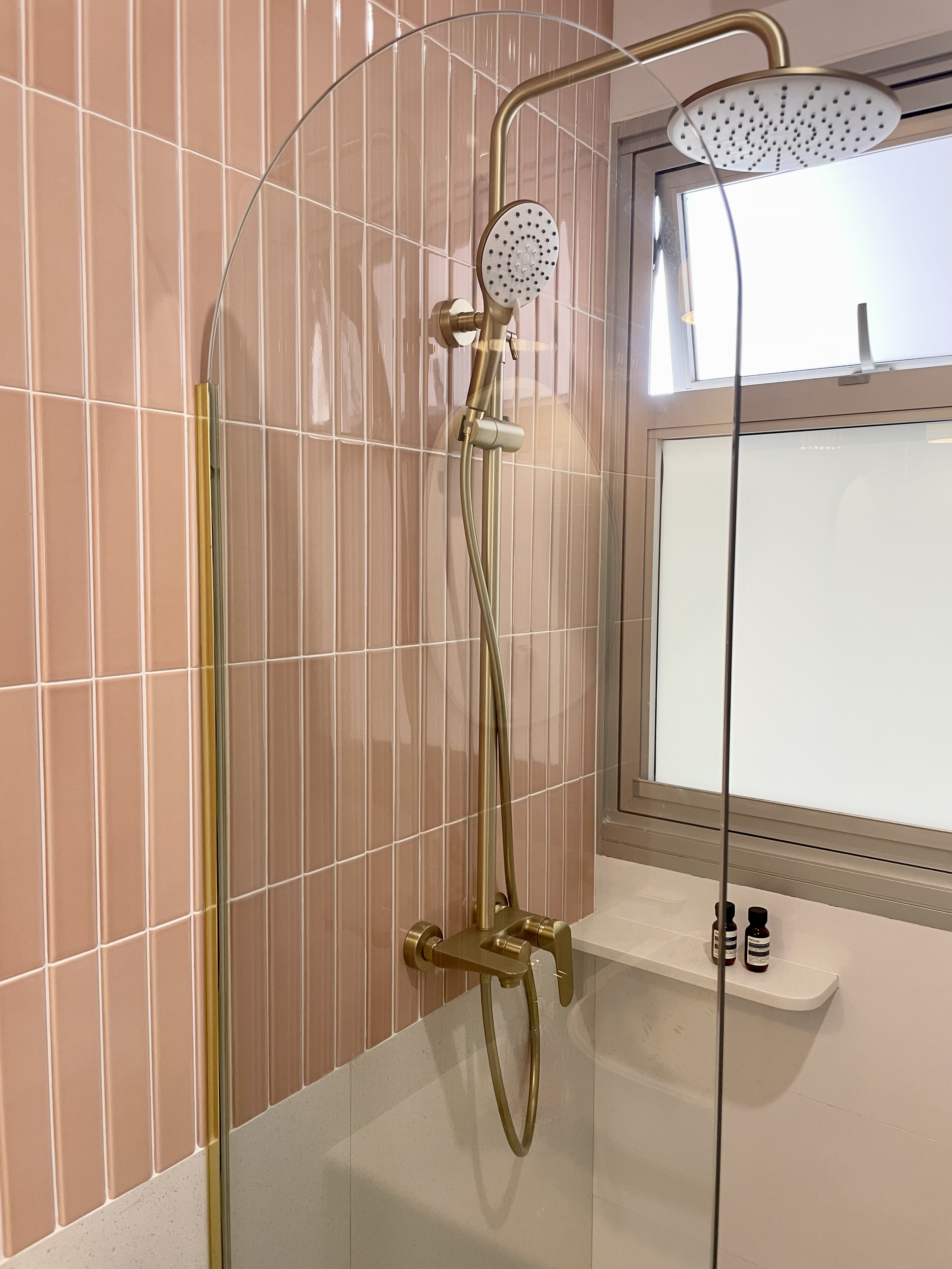 Dream Pink Bathroom without overlaying all walls - Golden shower head, pink tiled wall, modern shower fixture, transparent