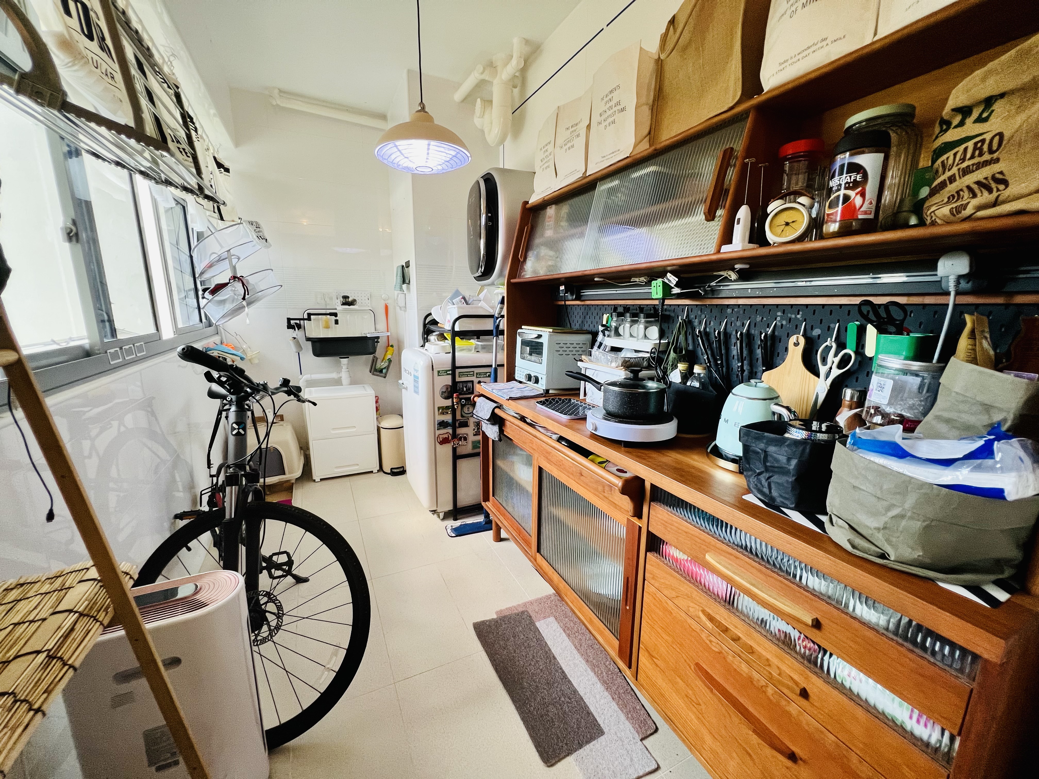 A Maximalist Haven ❤️ - bicycle, kitchen, storage, wooden cabinets, countertop, refrigerator, microwave, toaster, kettle