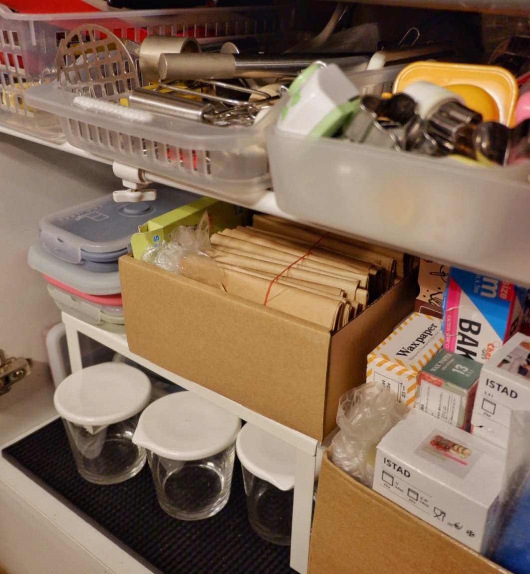Kitchen organisation  - Organized storage, cardboard boxes, plastic containers, kitchen tools, paper supplies, kitchen