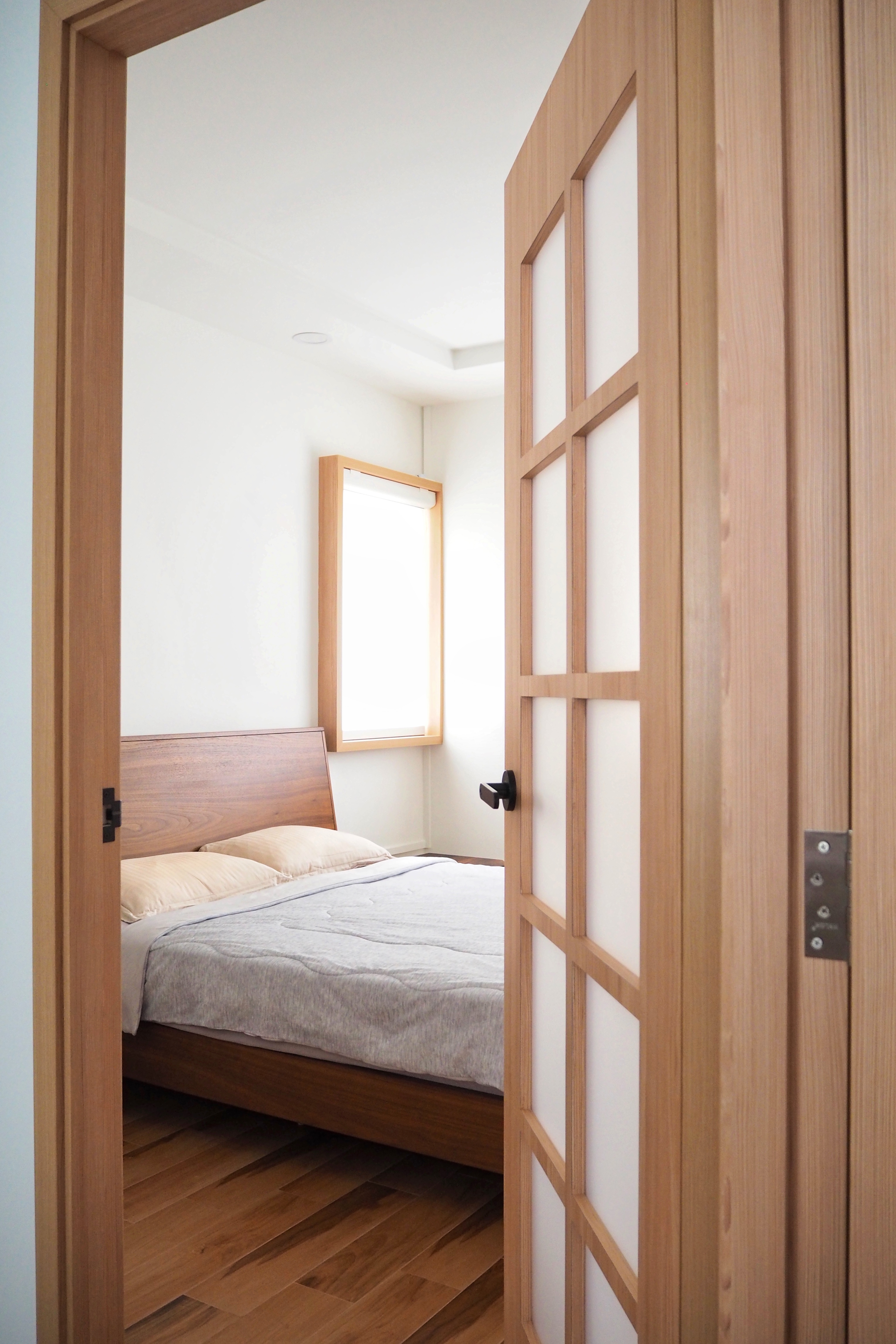 Tranquility in Our Master Bedroom  - Wooden door frame, wooden paneling, light wooden door, wooden headboard, wooden window