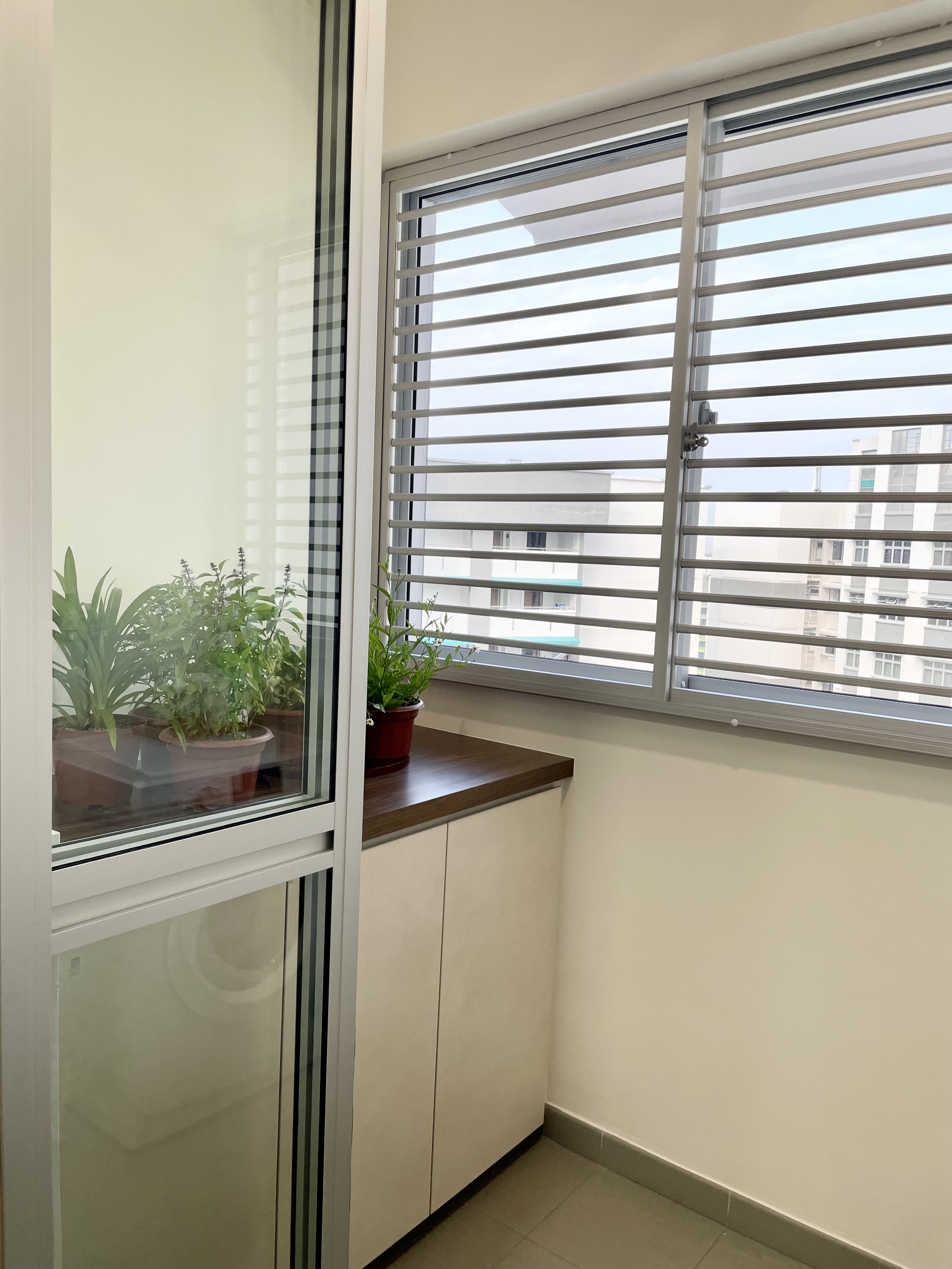 Maximizing your Service Yard - Interesting Sink + Cabinet - Modern apartment, large window, white blinds, indoor plants