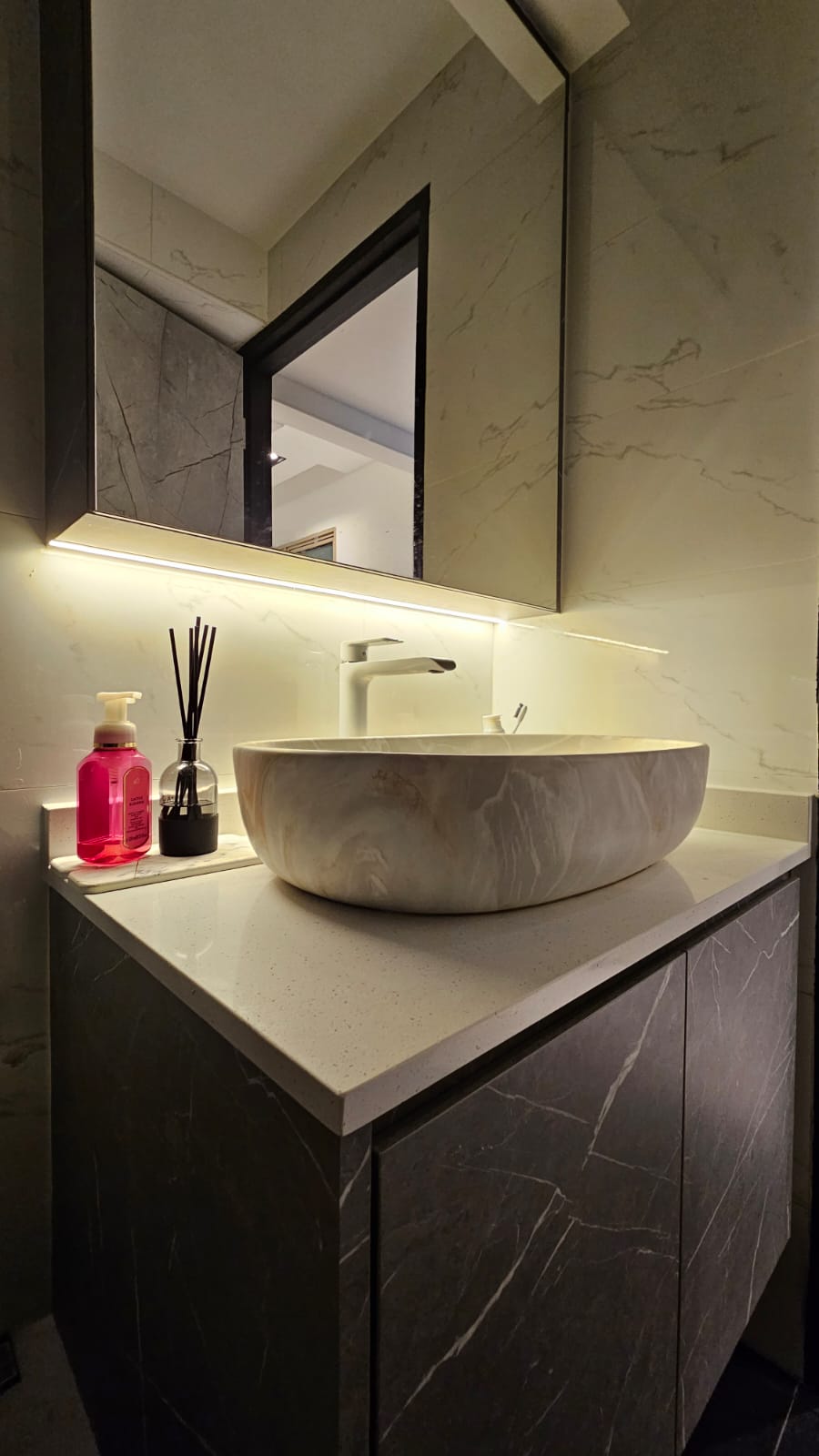 Chic Simplicity: Tranquil Beauty of Grey and White - Marble-textured sink, sleek vanity, modern bathroom, under-cabinet
