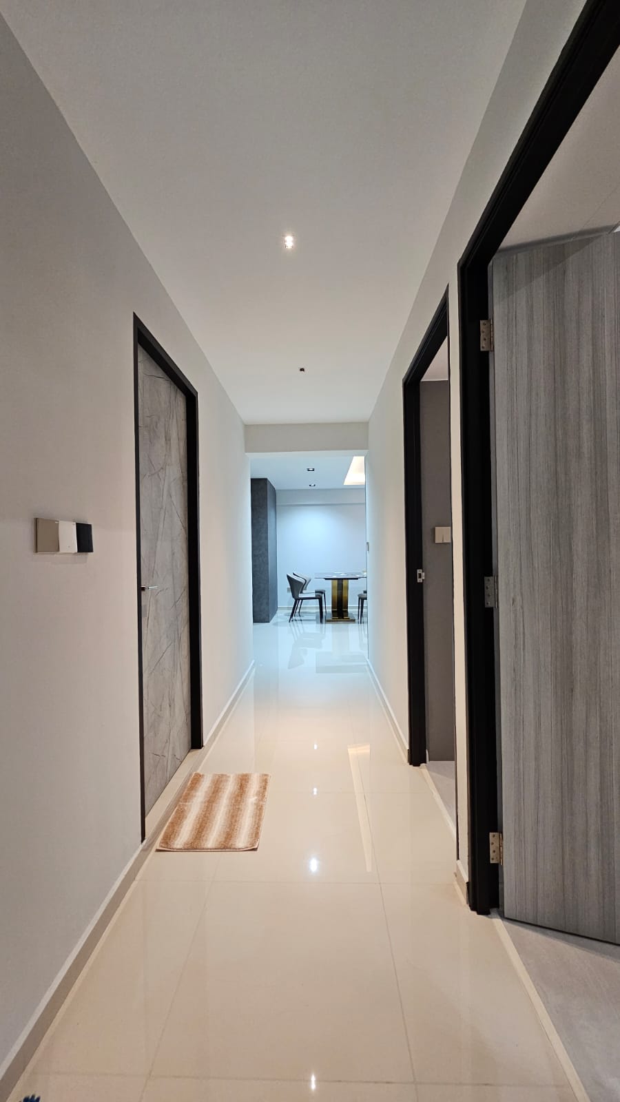 Chic Simplicity: Tranquil Beauty of Grey and White - Modern minimalist hallway, sleek white tile floor, recessed ceiling