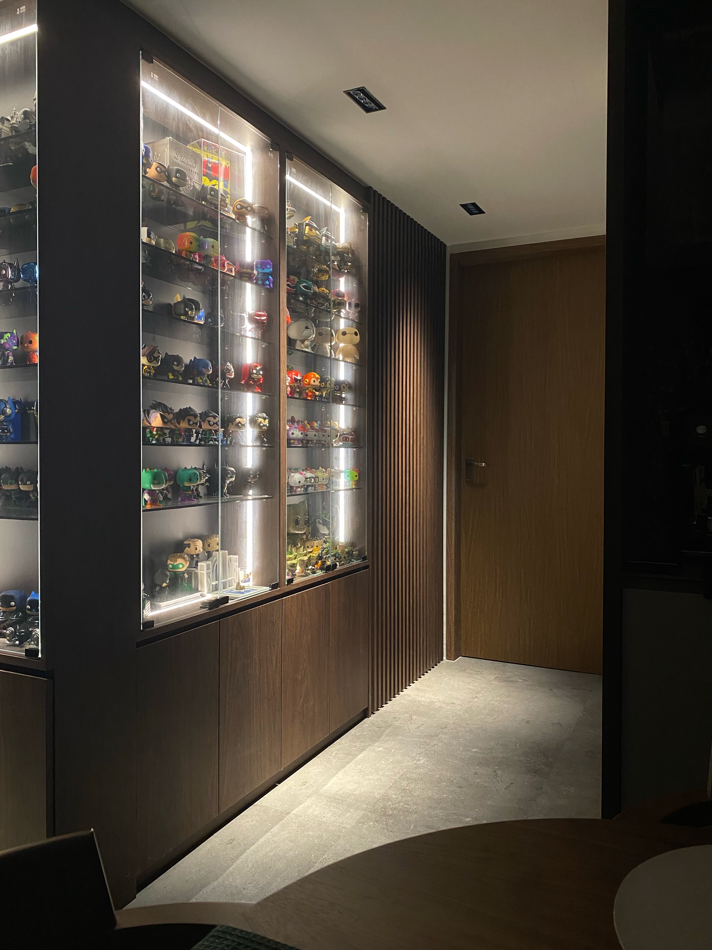 Masterpiece: Showcasing the showcase that showcases our showcase - Shelf filled with Funko Pop figures, sleek dark wooden