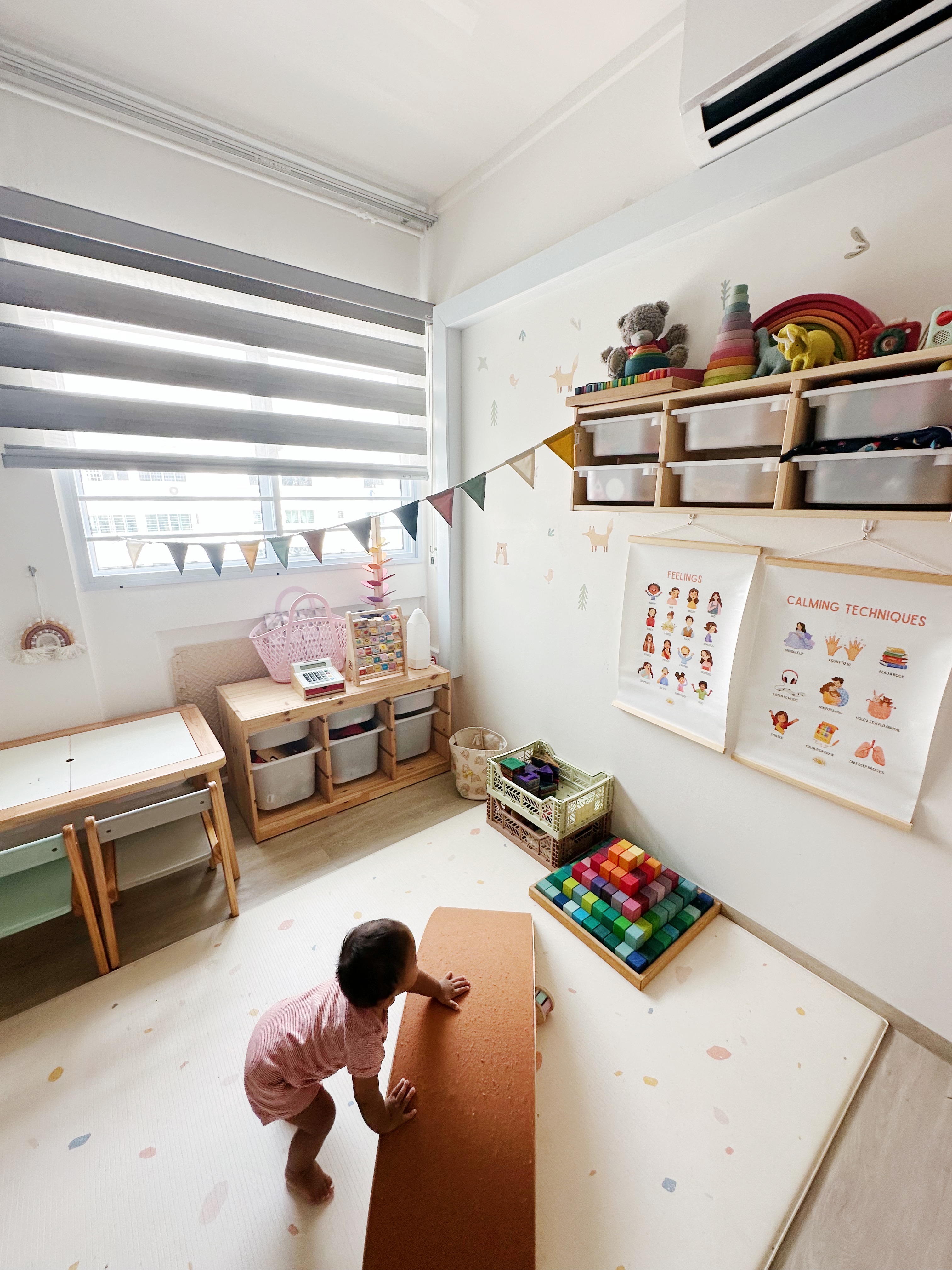 Playroom / Bedroom - Children's playroom, colorful toys, educational posters, wooden furniture, rainbow wall decals, alphabet