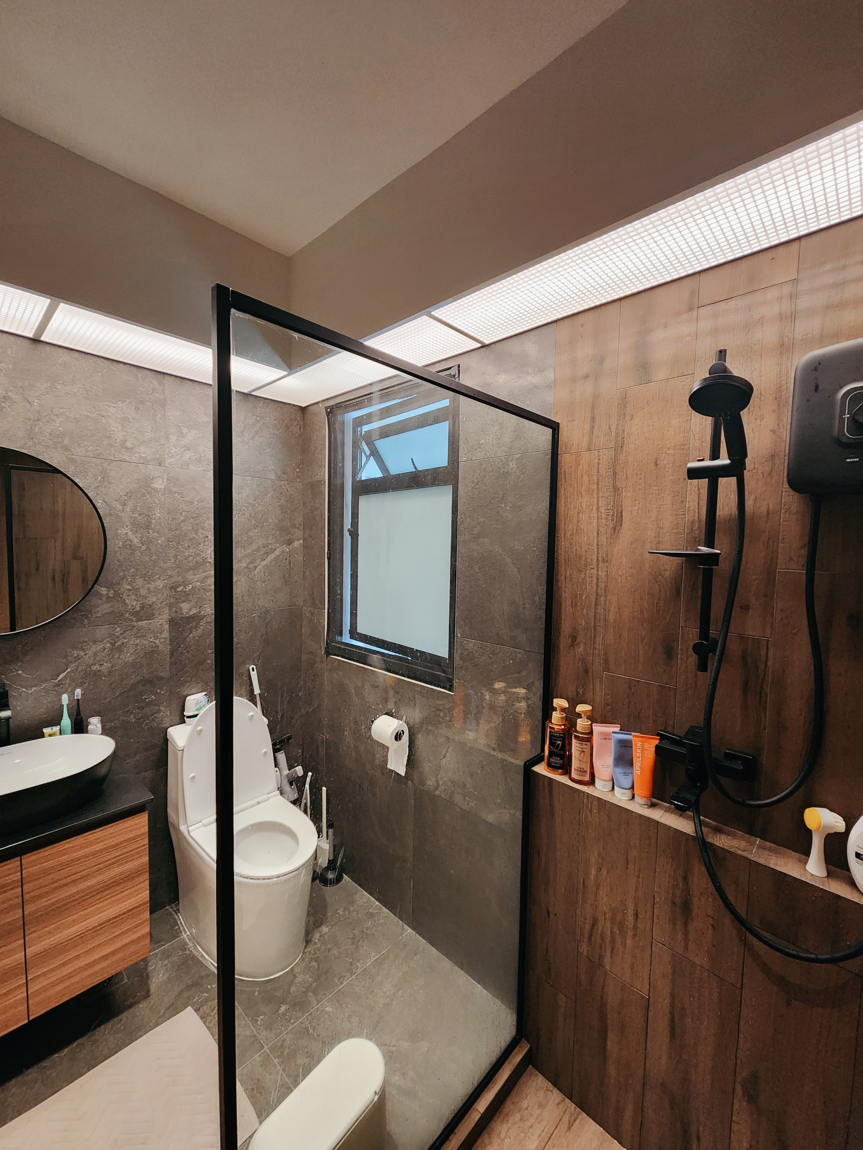 $10k reno for our toilets? Totally worth it!  - Modern bathroom with sleek design, glass shower enclosure, wooden accents