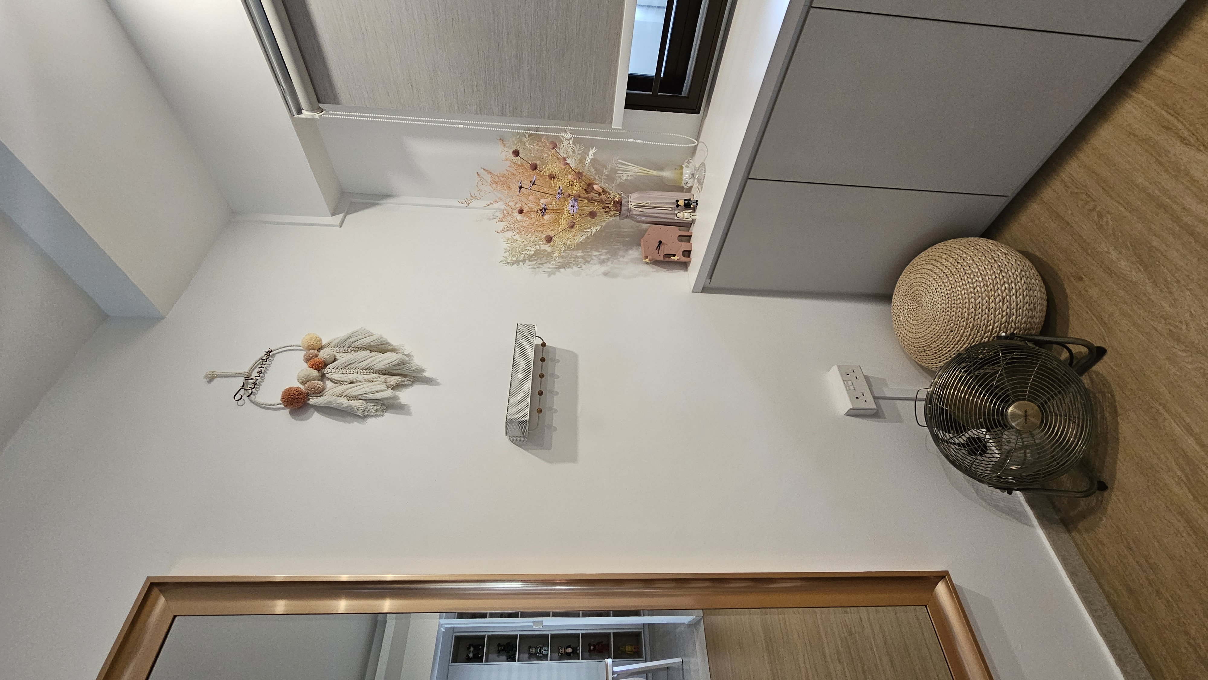 Entryway...or not? - Modern minimalist decor, white wall, wooden trim, open door, light fixture, decorative wreath, small