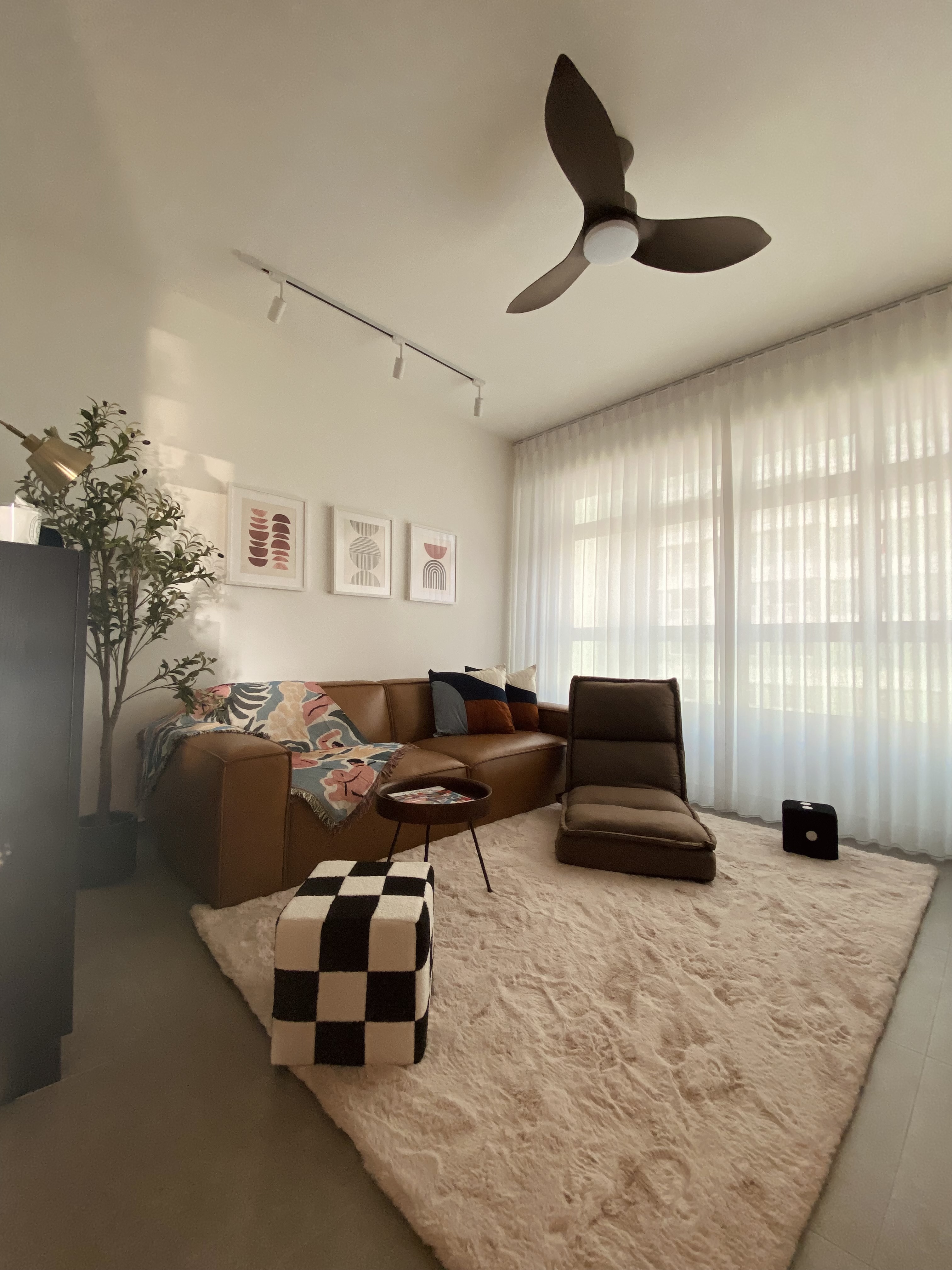 Step into our dwelling - a mixture of styles!  - Modern living room with beige carpet, brown leather sofa, colorful throw