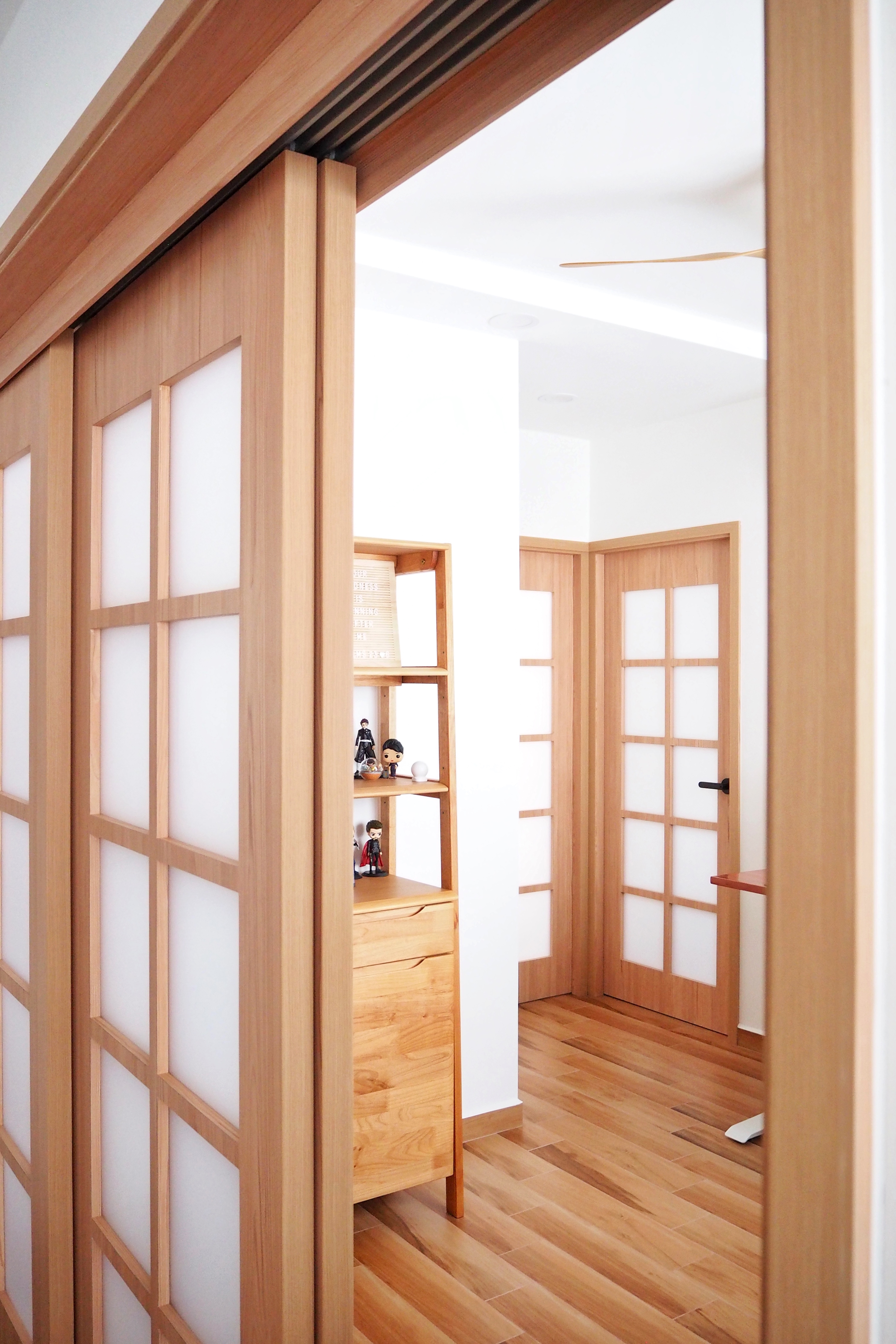 Our Concealable Workspace - Wooden door with glass panels, minimalist interior design, wooden shelf with figurines, wooden