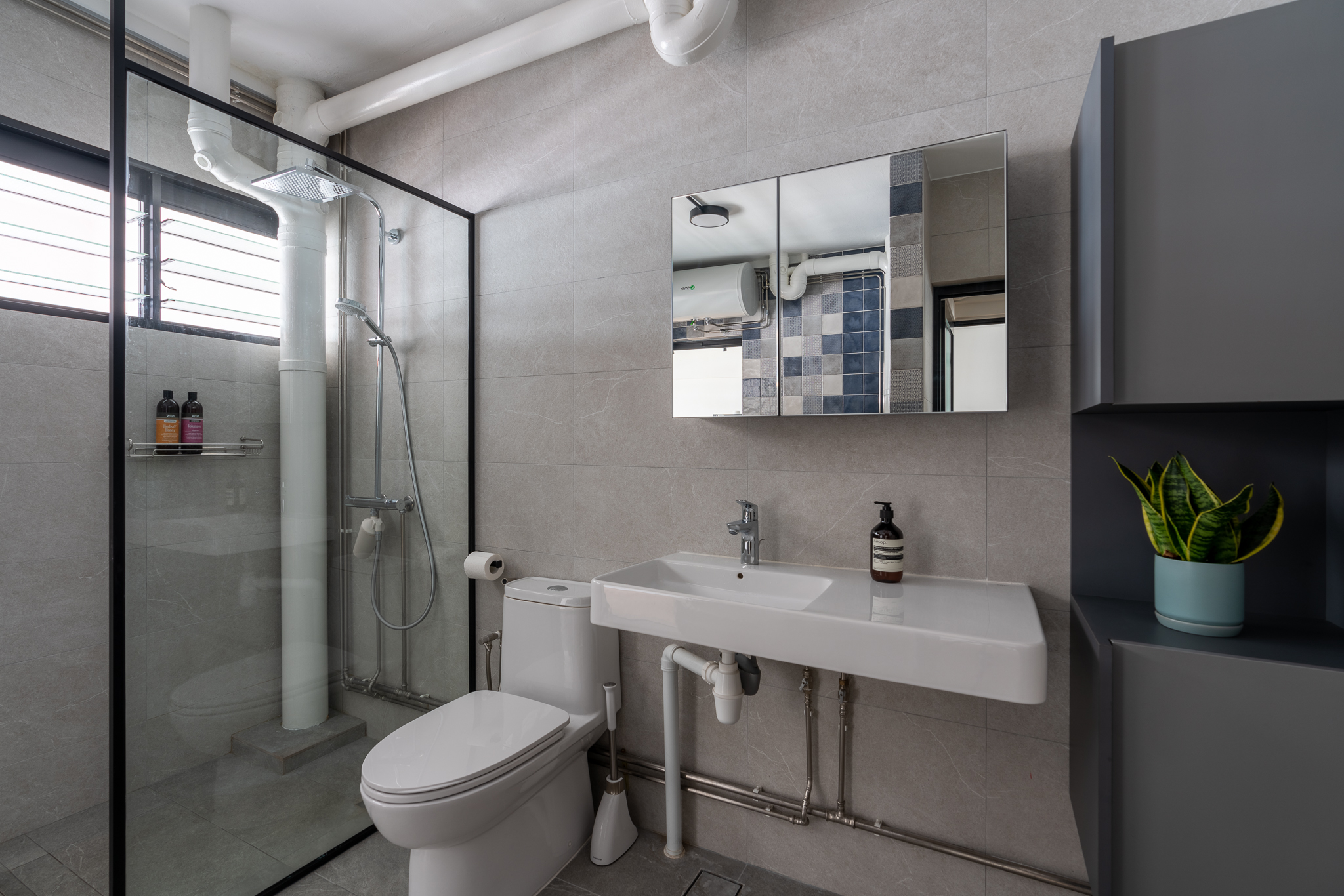 Supersizing Our Bathroom - Modern bathroom with glass shower enclosure, white toilet, white sink with faucet, gray tiled