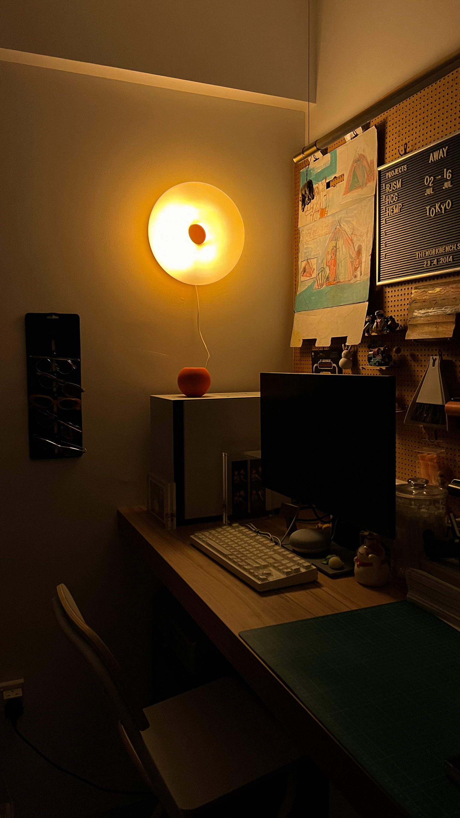 Crafting Your Personal Haven: Redefine Your Space - dimly lit workspace, cozy desk, computer setup, white keyboard, black