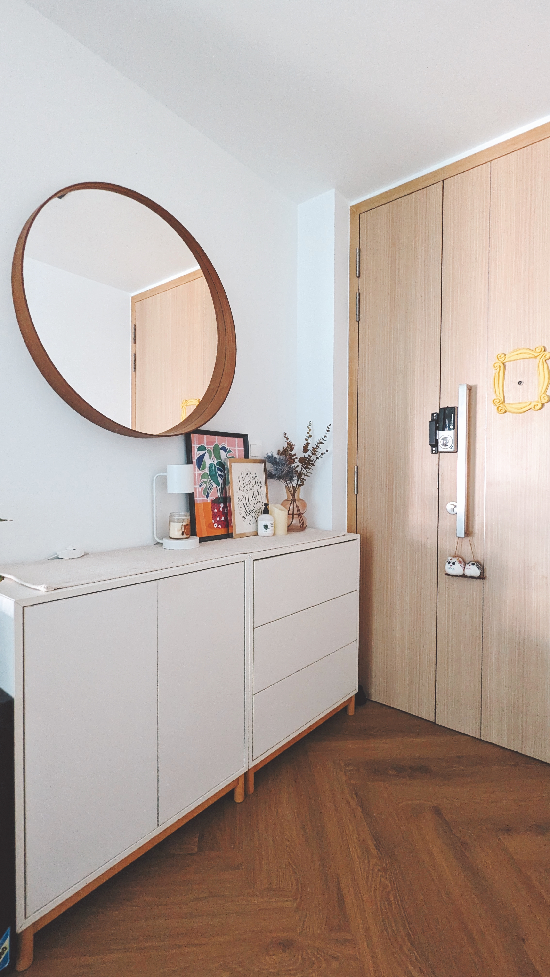 Walk about our quirky, catto-loving space. - White vanity with wooden legs, round mirror with wooden frame, wooden door with