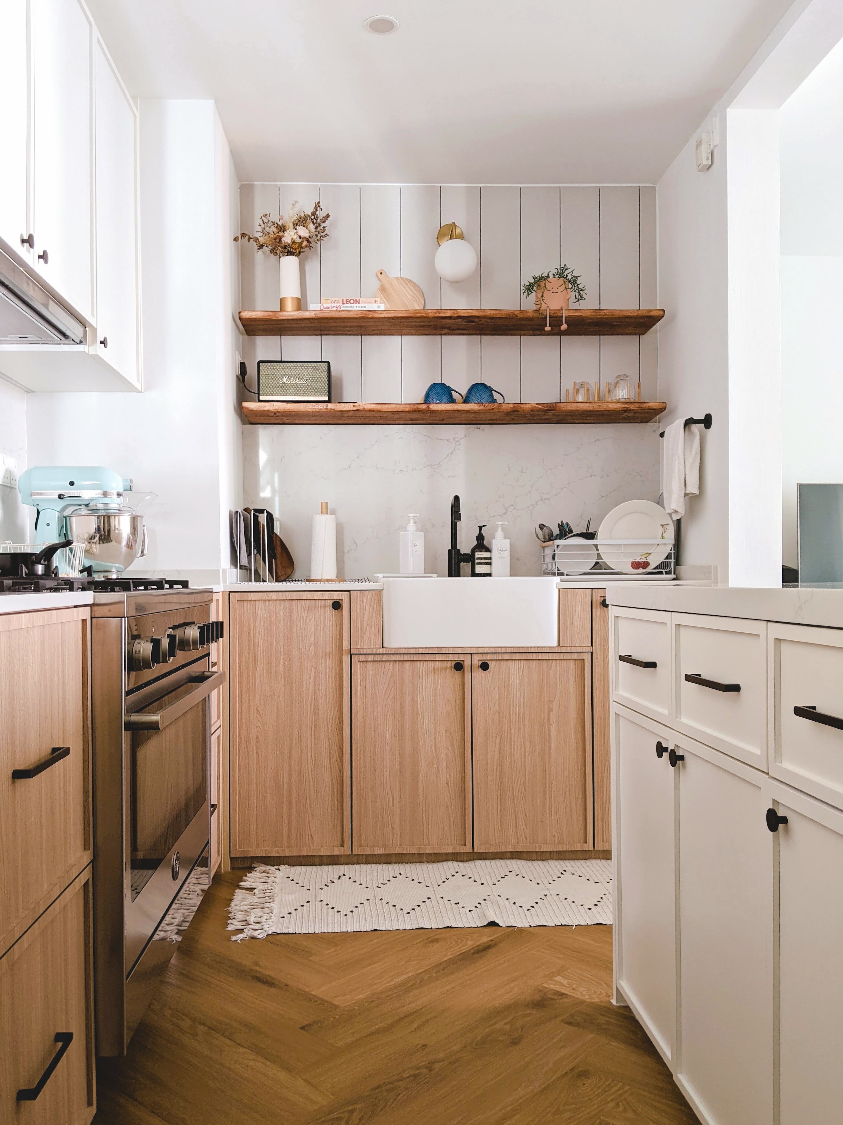 Walk about our quirky, catto-loving space. - Wooden kitchen cabinets, white countertops, modern appliances, light wood