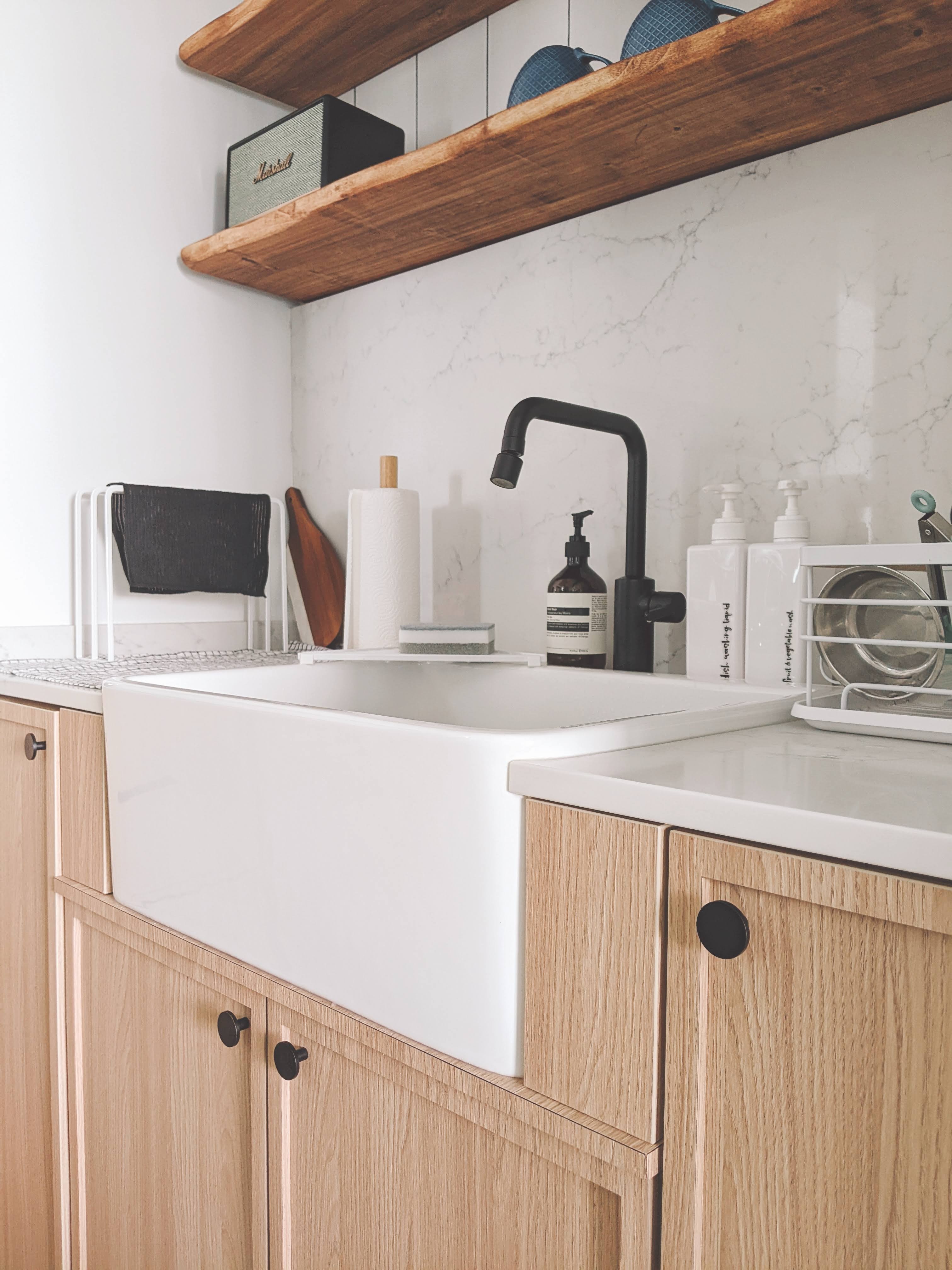 Walk about our quirky, catto-loving space. - Wooden kitchen cabinets, white countertop, black faucet, black soap dispenser