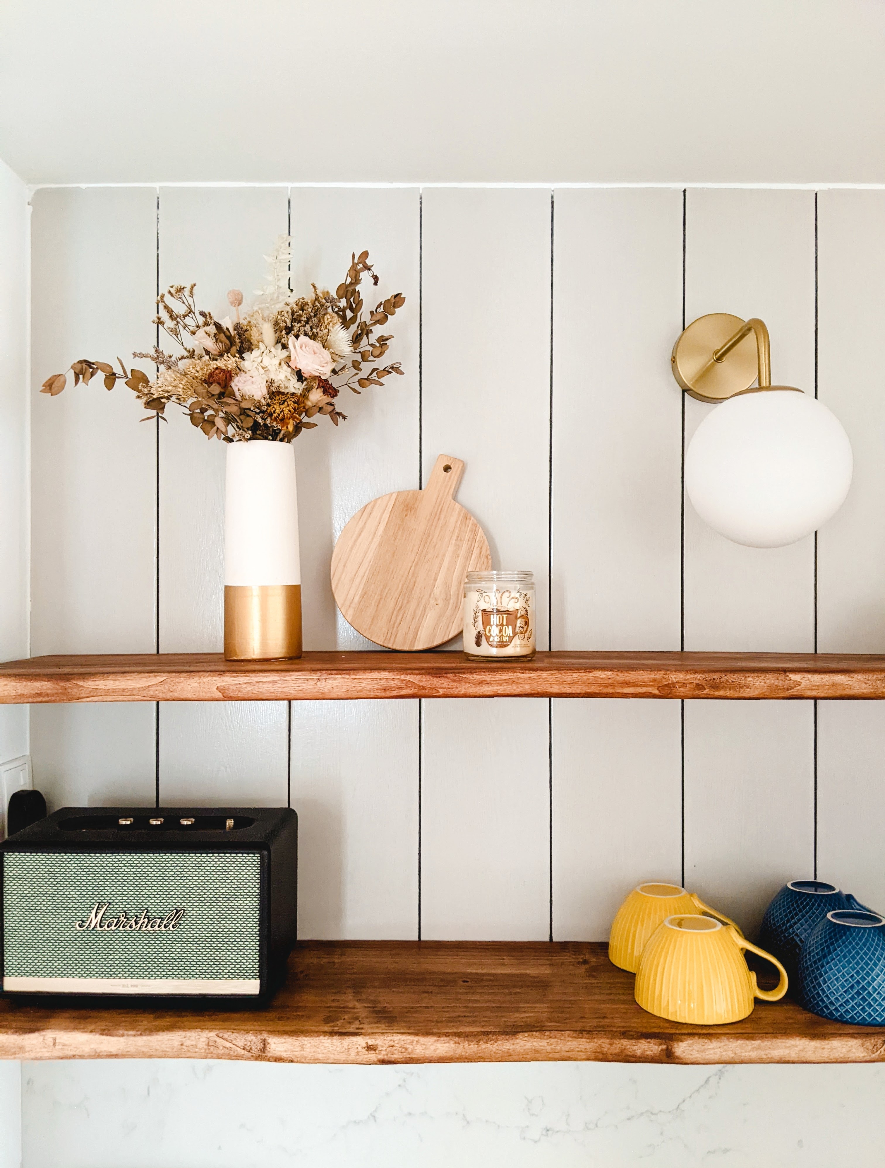 Walk about our quirky, catto-loving space. - vibrant floral arrangement, rustic wooden shelf, modern pendant light, vintage