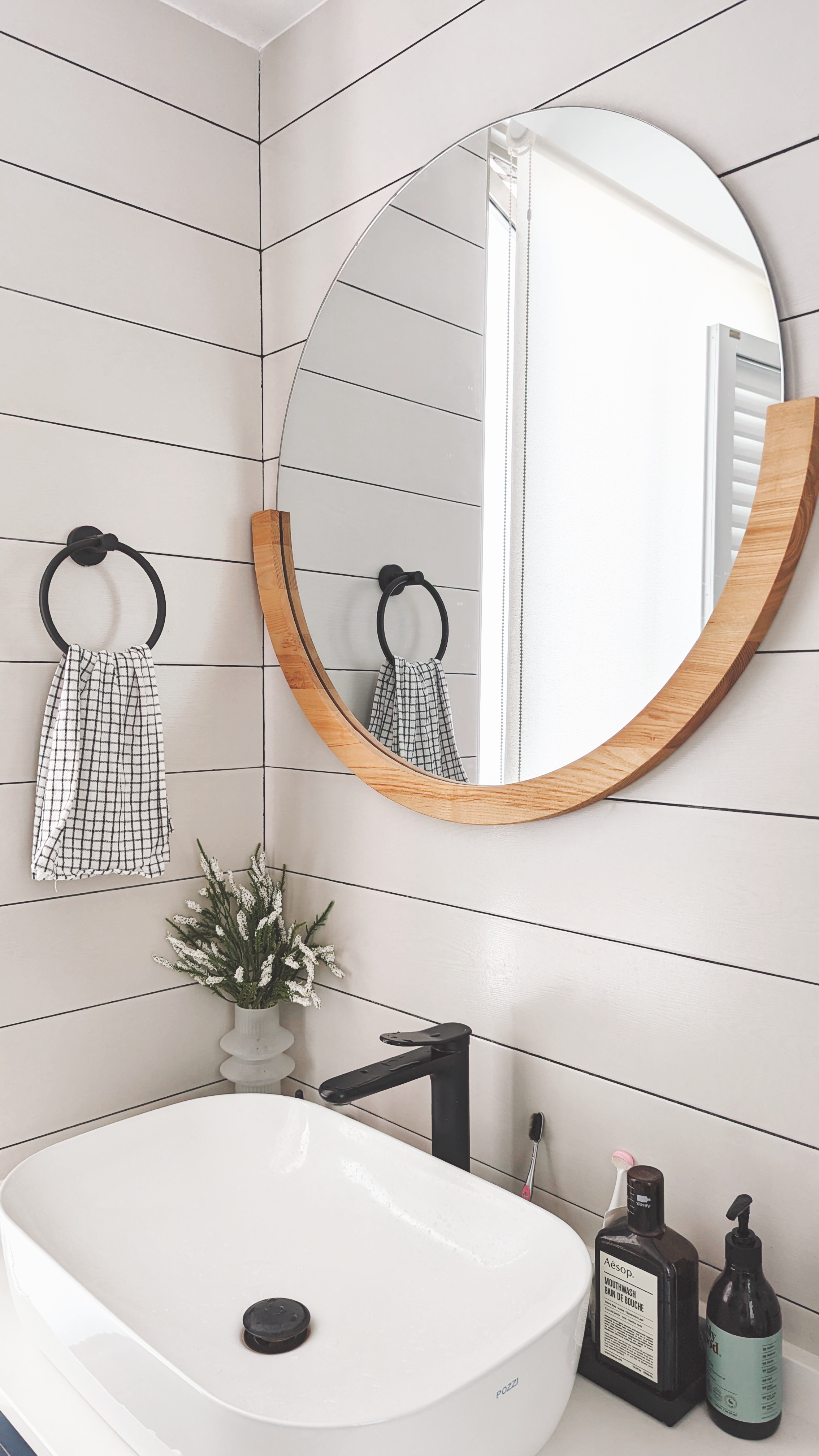 Walk about our quirky, catto-loving space. - White bathroom vanity, modern design, floating sink, black faucet, white tiles