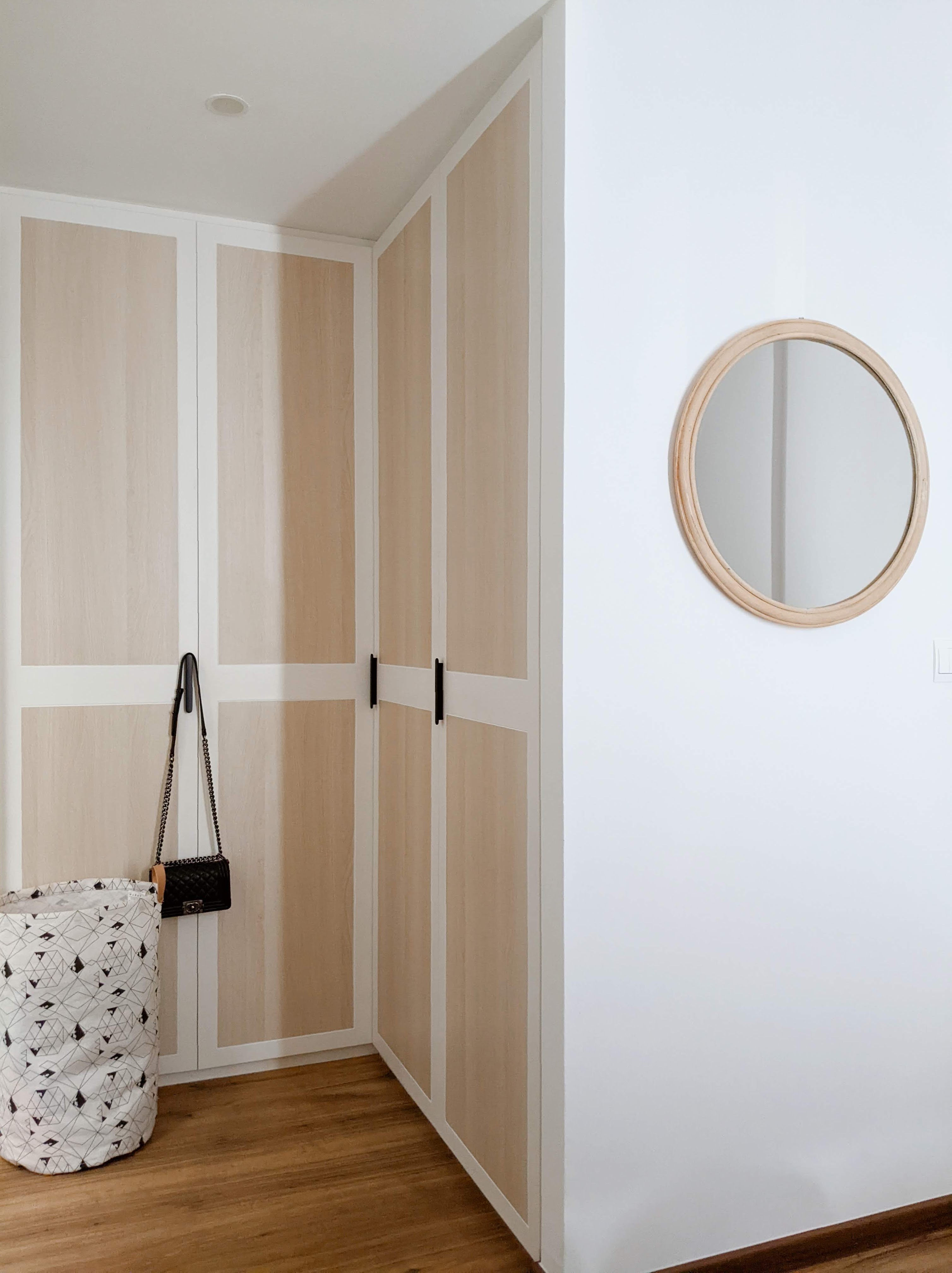 Walk about our quirky, catto-loving space. - Wooden wardrobe with black handles, geometric patterned bag hanging, minimalist