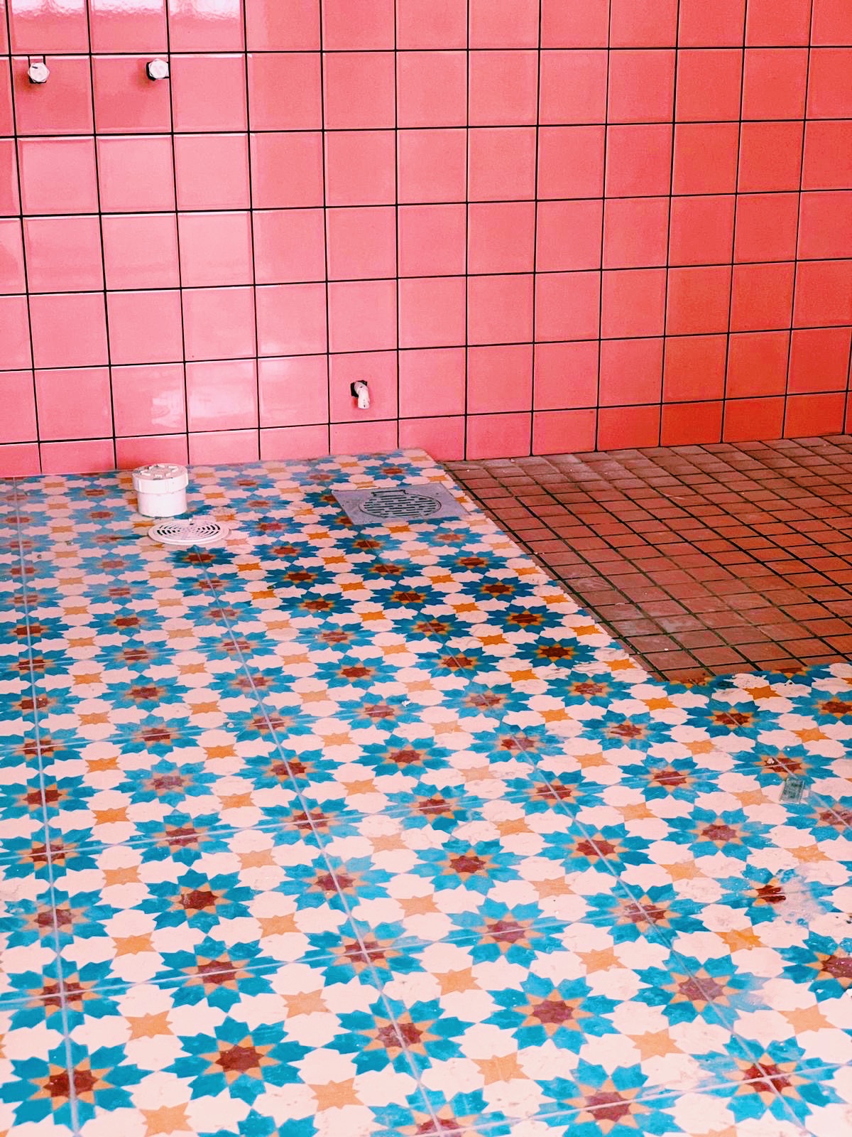 Where Every Bathroom Break is a Mini Getaway! - Vibrant tiled floor with intricate star patterns and contrasting colors, Pink