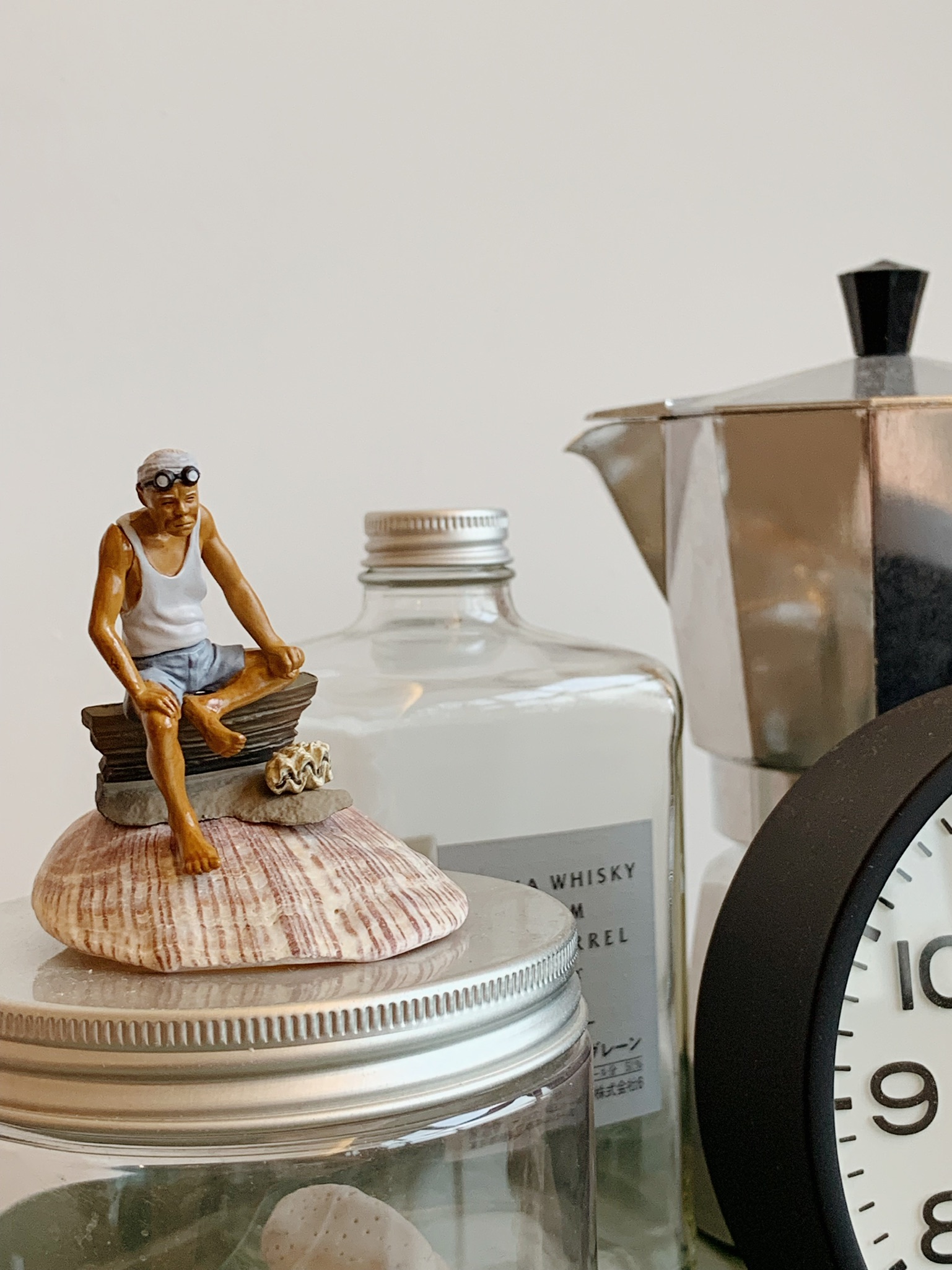 From Living Room to Entertainment Central: The Ultimate Transformation - sitting man on shell, vintage clock, vintage bottle