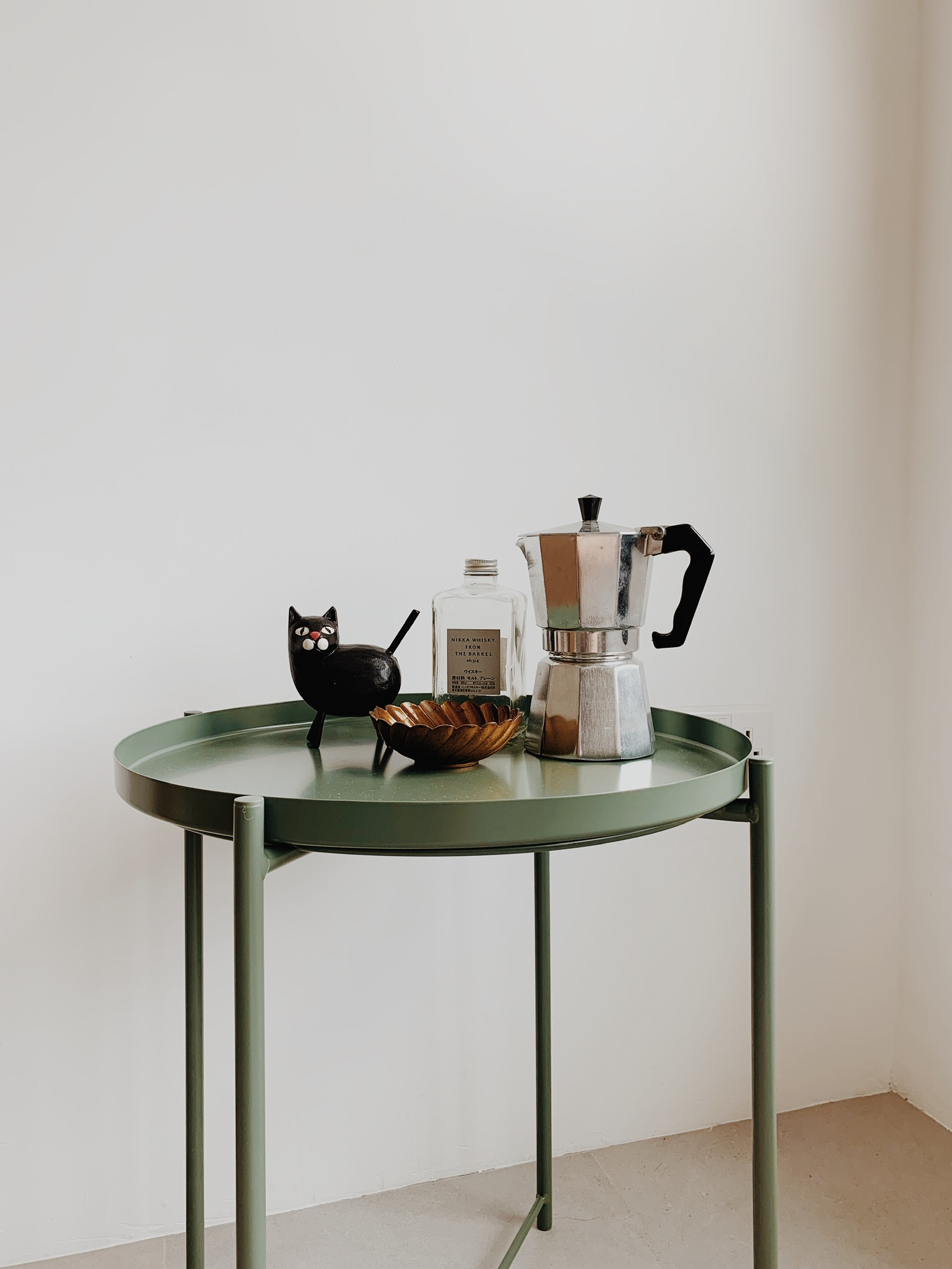 From Living Room to Entertainment Central: The Ultimate Transformation - green table, minimalist setting, black cat figurine