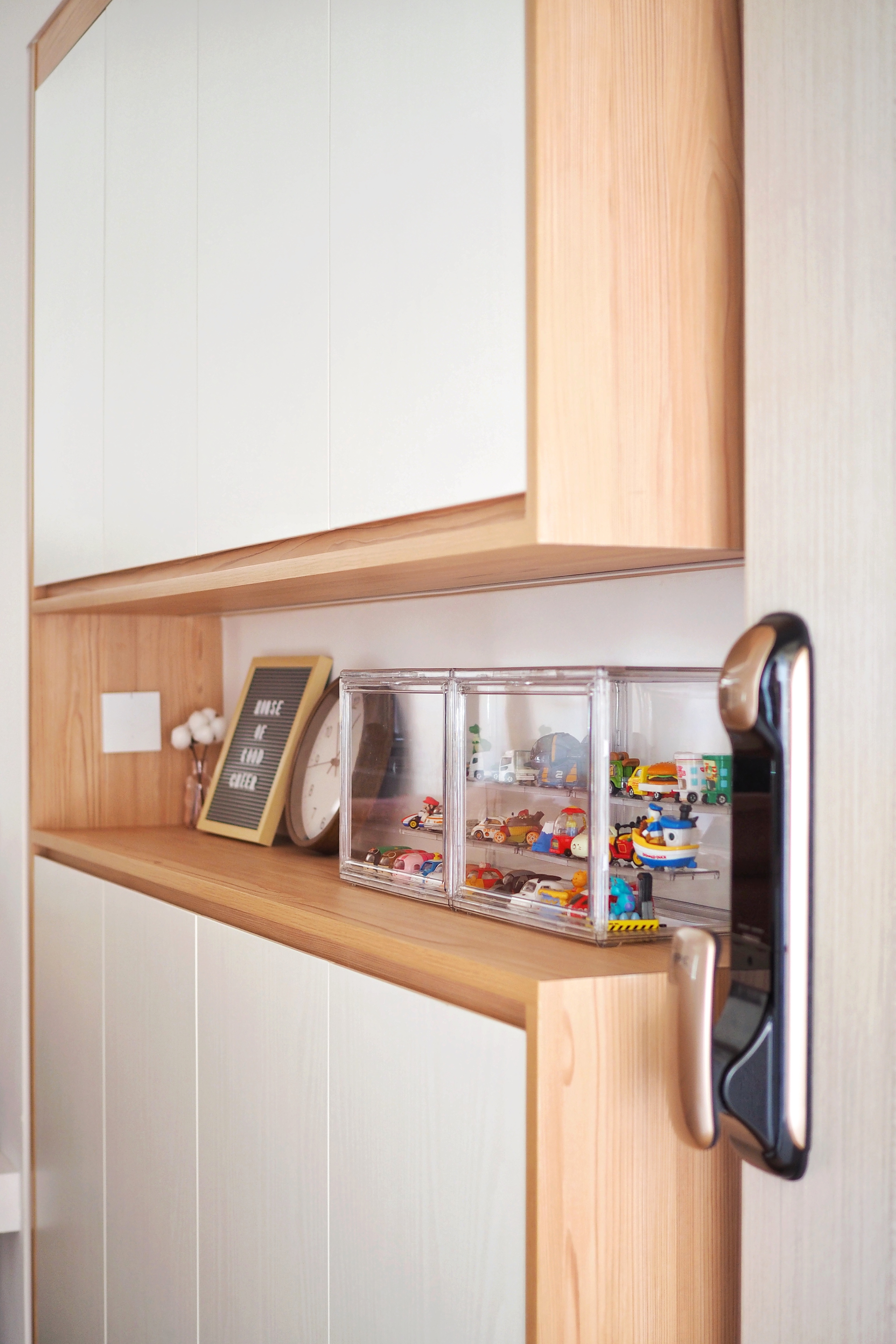 Maximising Space at Our Entryway - Wooden shelf, white cabinets, clear storage compartment, toy cars, colorful toys, toy