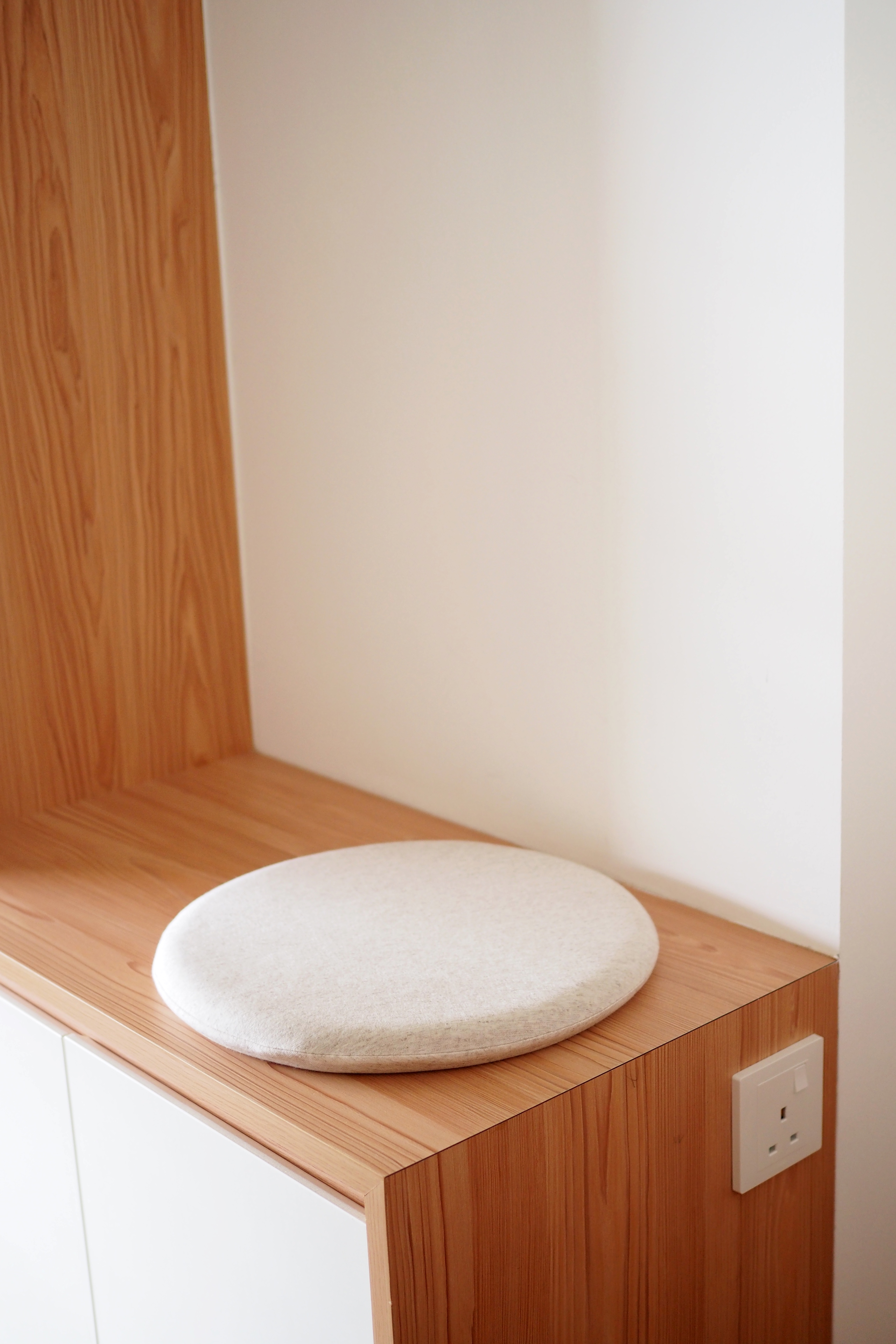 Maximising Space at Our Entryway - Wooden shelf, round cushion, minimalist design, light-colored fabric, wooden texture