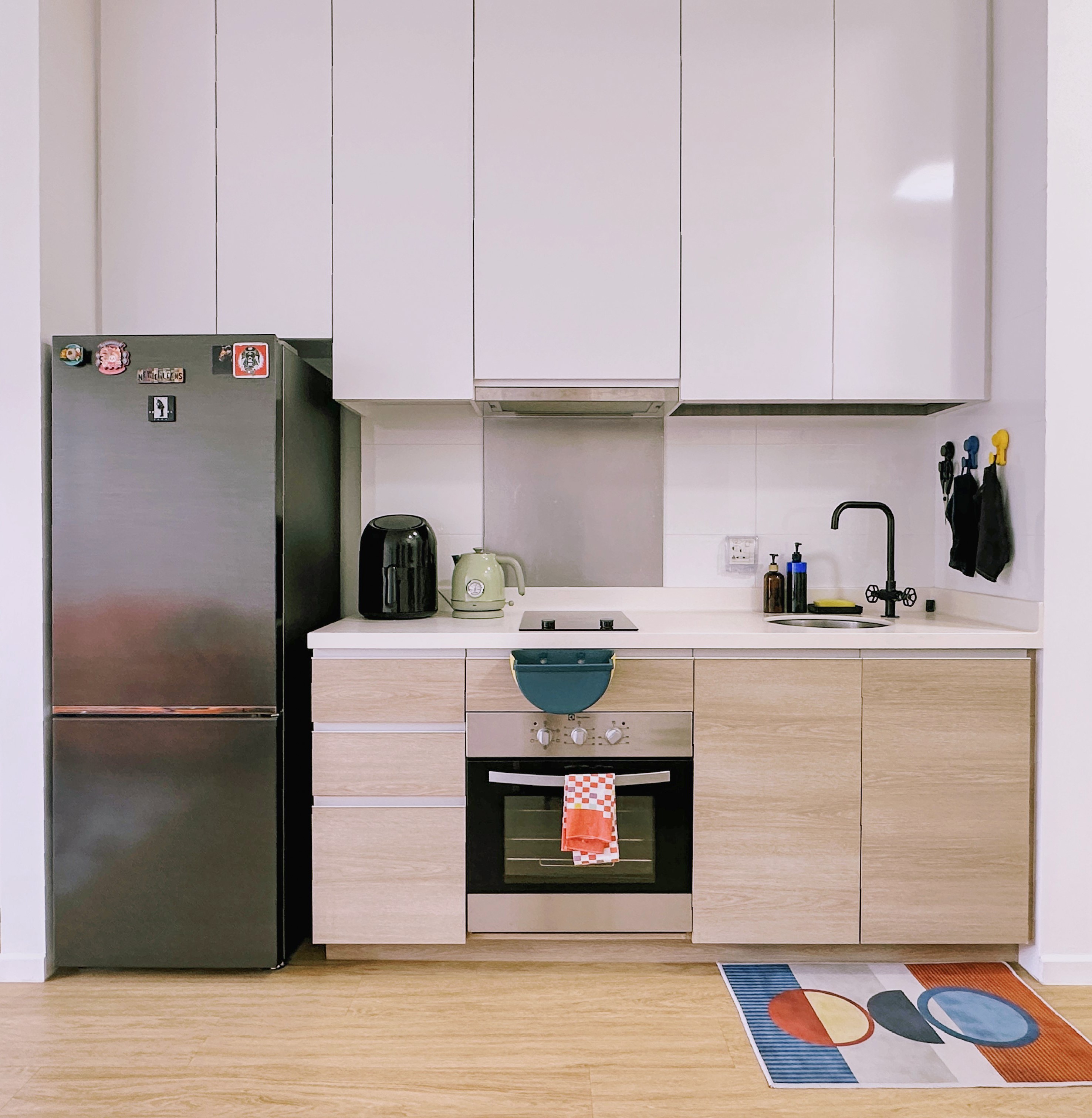 Our Dry, Open-Concept Kitchenette In A 2-Bedroom House - Modern kitchen with stainless steel refrigerator, light wood