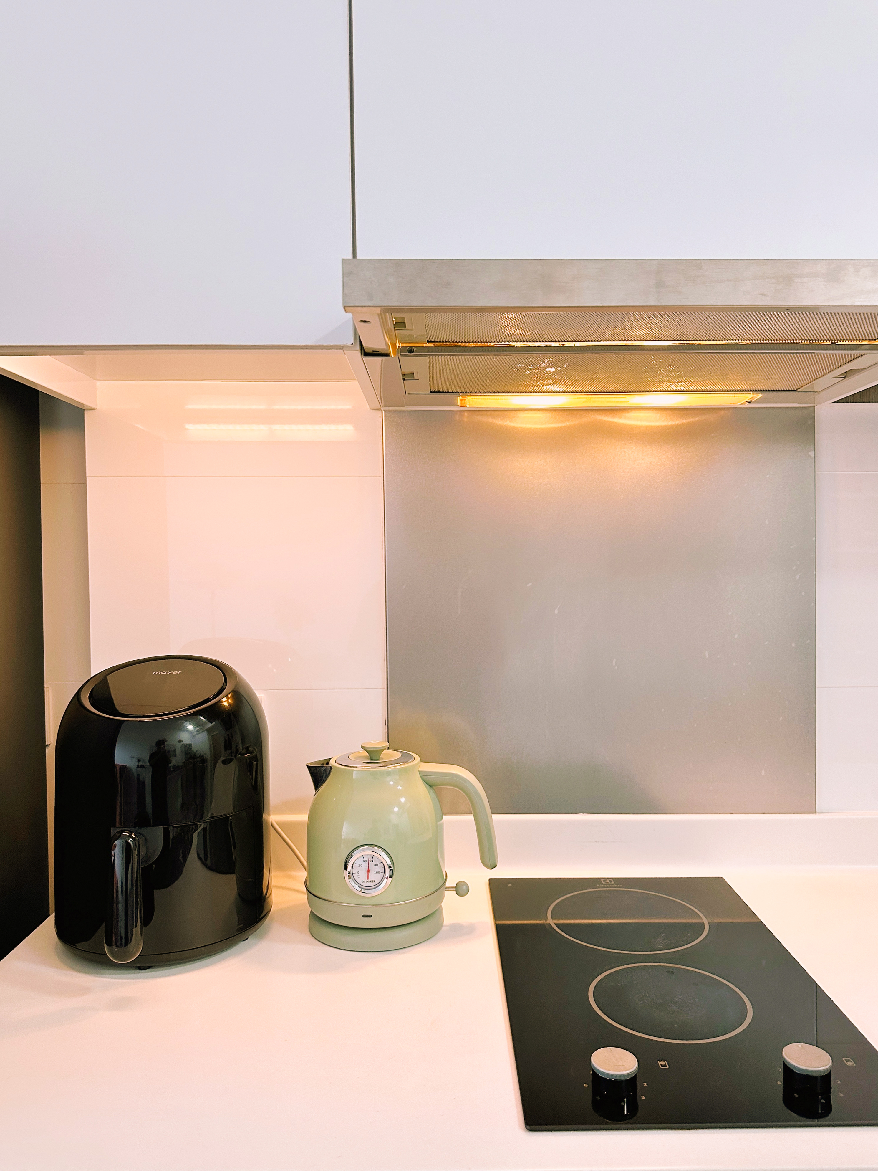 Our Dry, Open-Concept Kitchenette In A 2-Bedroom House - Modern kitchen countertop, black coffee maker, light green electric