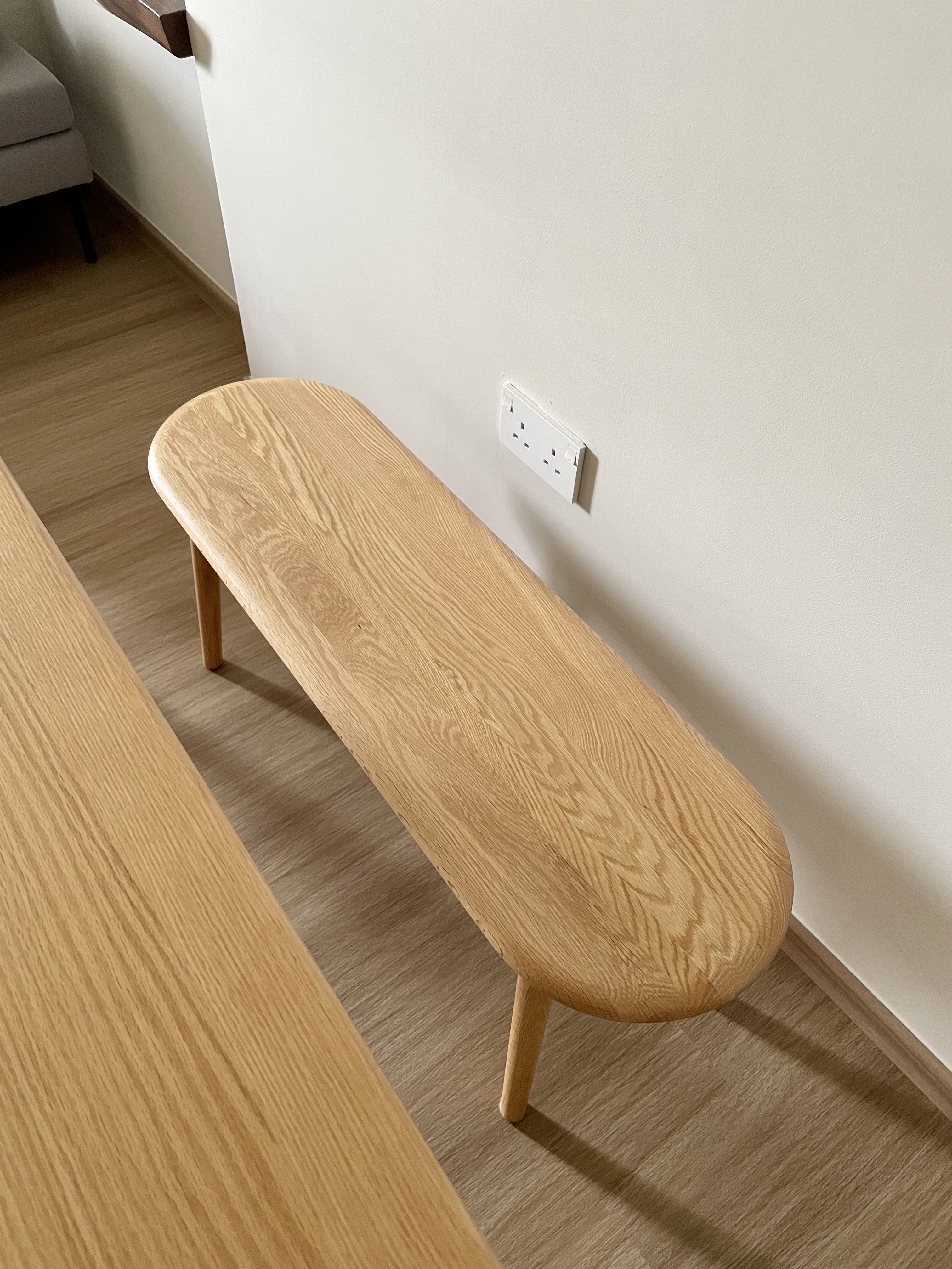 Japandi style dining area  - Wooden bench, minimalist design, light wood finish, natural texture, simple structure, cozy