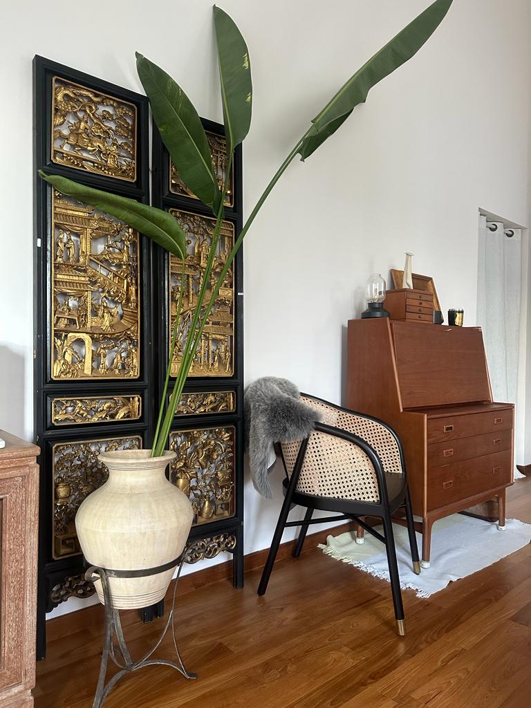 styling bedroom with existing furniture - Gold-embellished cabinet, large green plant, wooden floor, beige chair, black metal