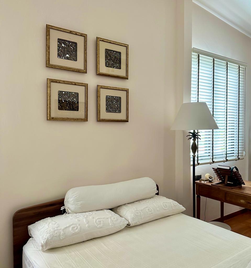styling bedroom with existing furniture - White bedding, framed artwork, wooden headboard, elegant bedside table, floor lamp