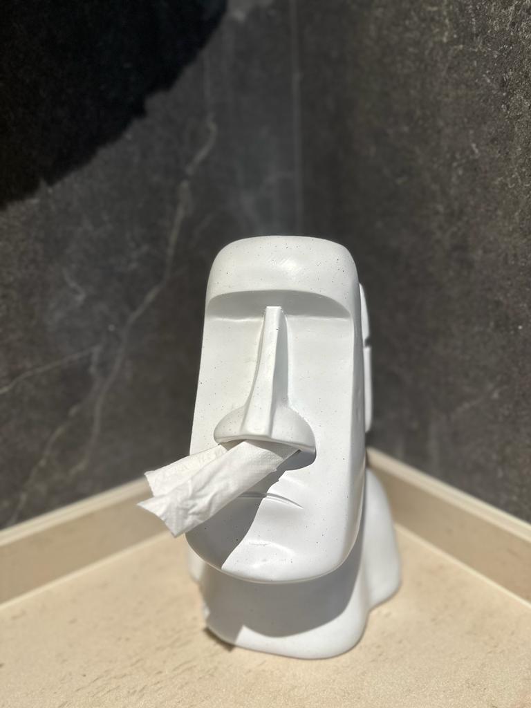 Immerse your senses in a dark and relaxing bathroom - White toilet-shaped object, black marble background, toilet paper roll