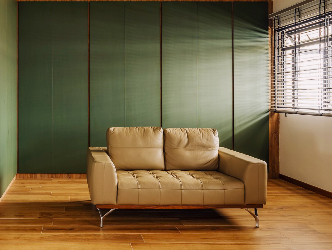 Sofa, so good - Modern minimalist living room, beige leather sofa, wooden floor, green accent wall, horizontal blinds
