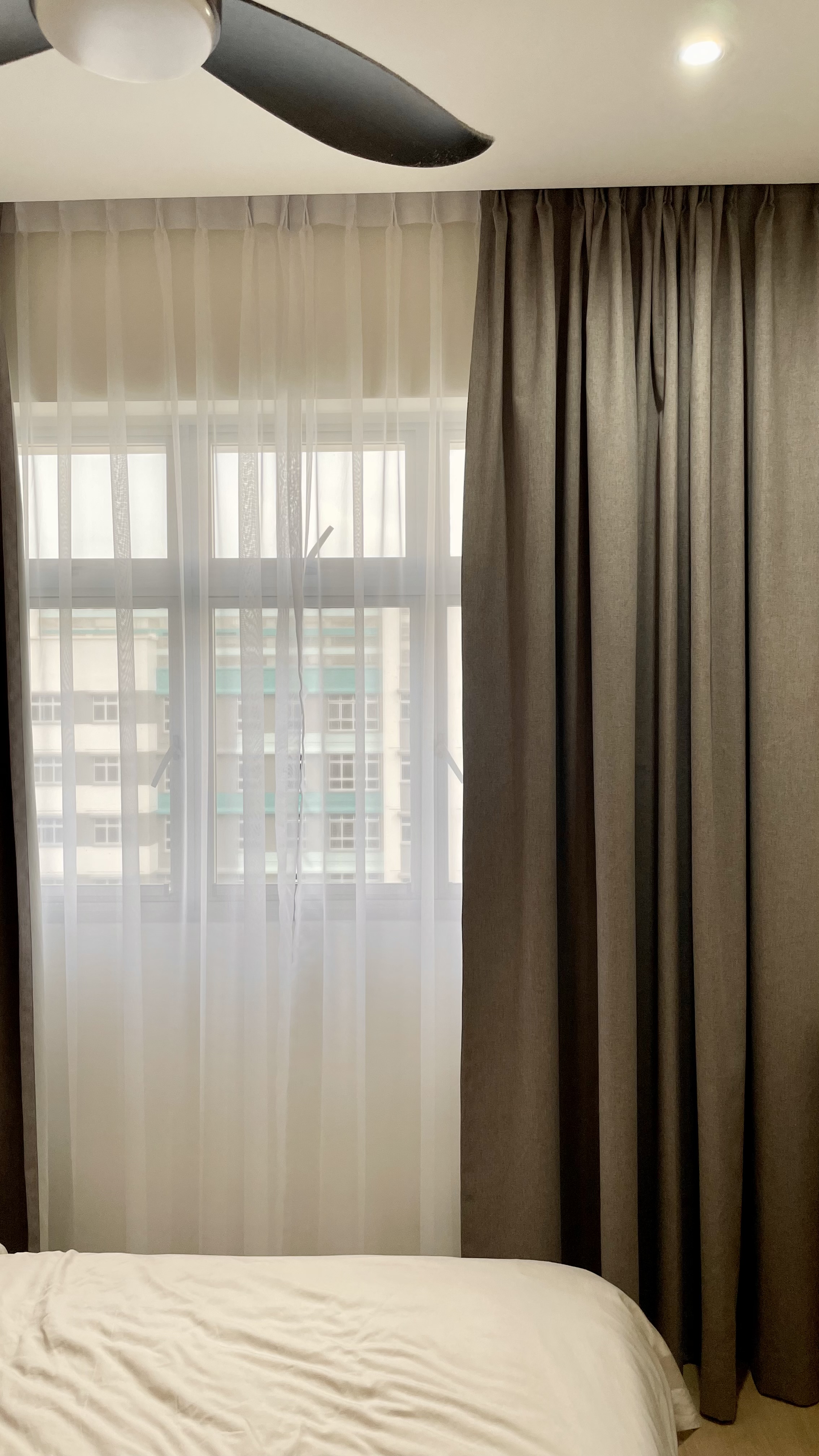 Japandi Bedroom  - Gentle morning light filters through sheer white curtains, softly illuminating the room. A serene bedroom