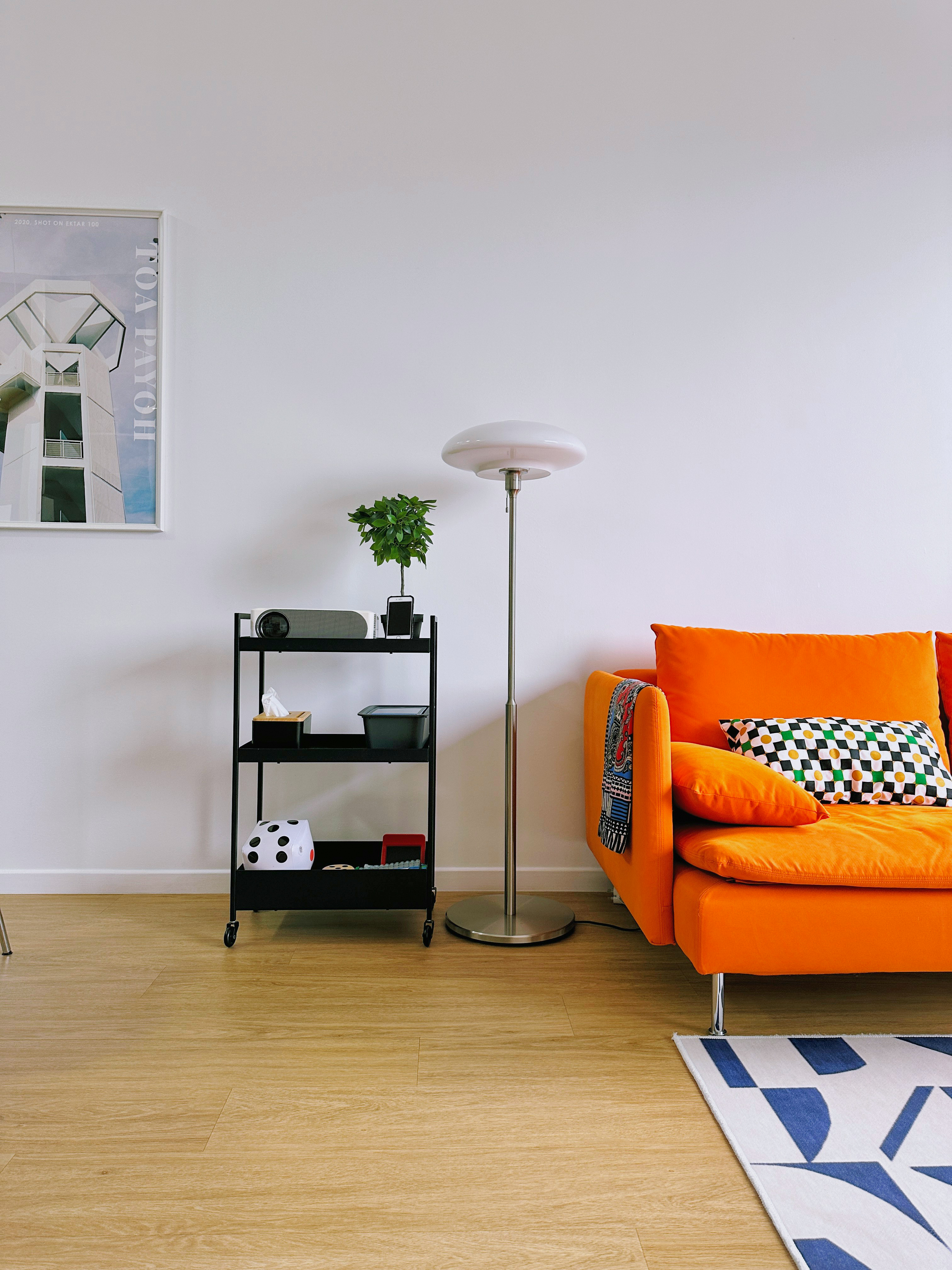 Cozy Home Theatre! (AKA Multi-Purpose Living Room) - Modern minimalist living room, sleek black side table, vibrant orange
