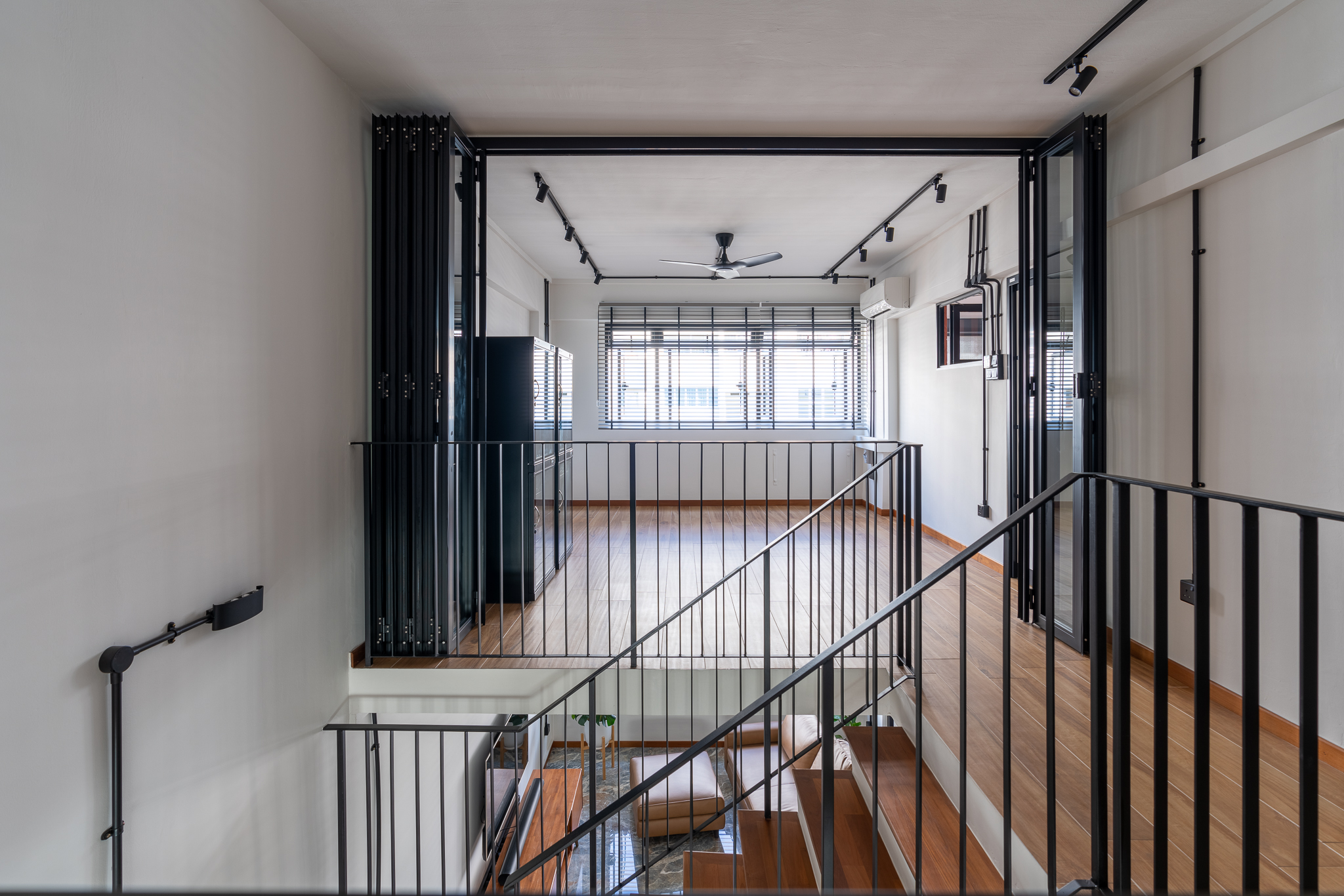 Breaking Walls and Perspectives - Modern minimalist interior, sleek black railings, spacious open floor plan, large windows
