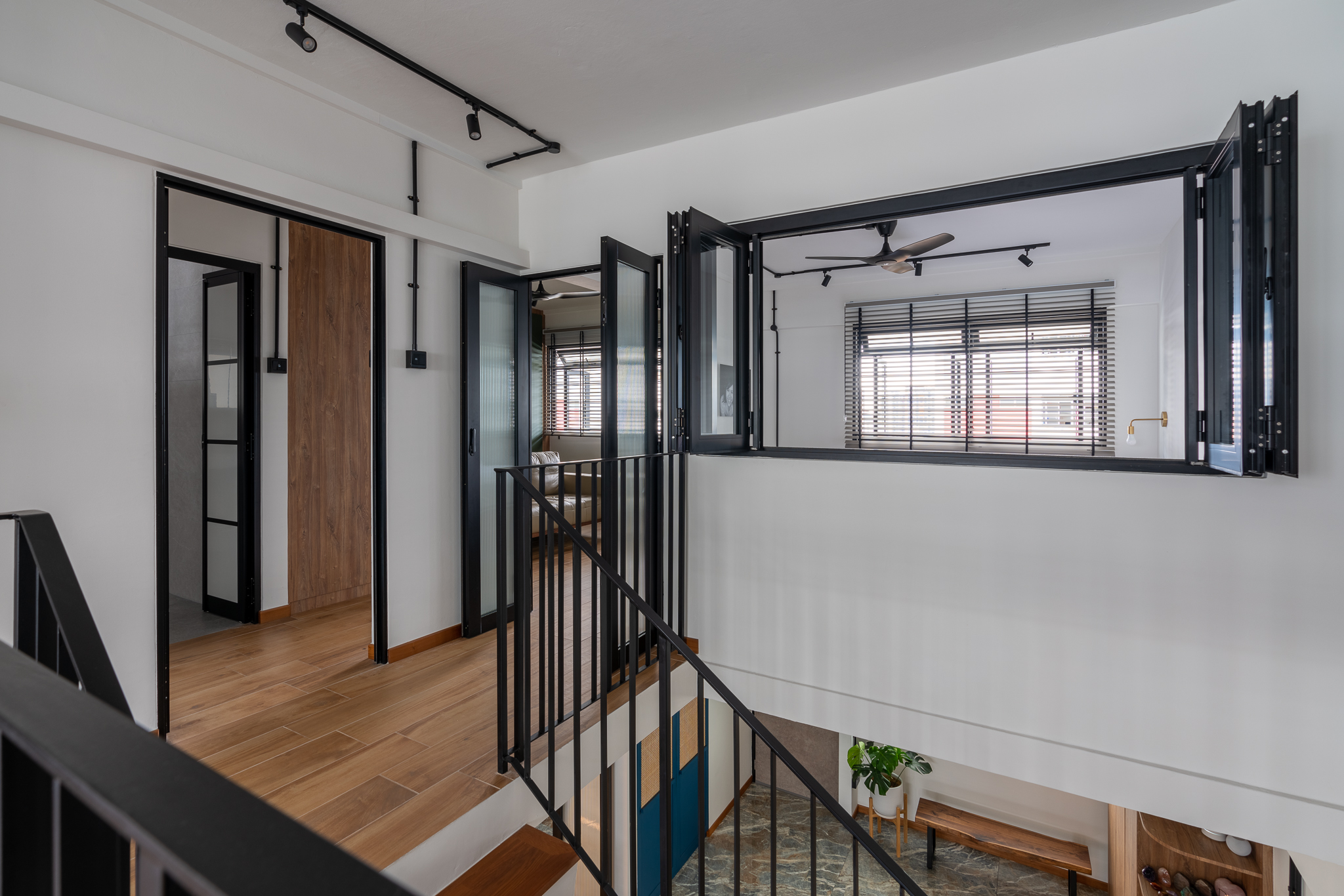 Breaking Walls and Perspectives - Modern interior design, open wooden doors, black metal frame, wooden floor, black railing