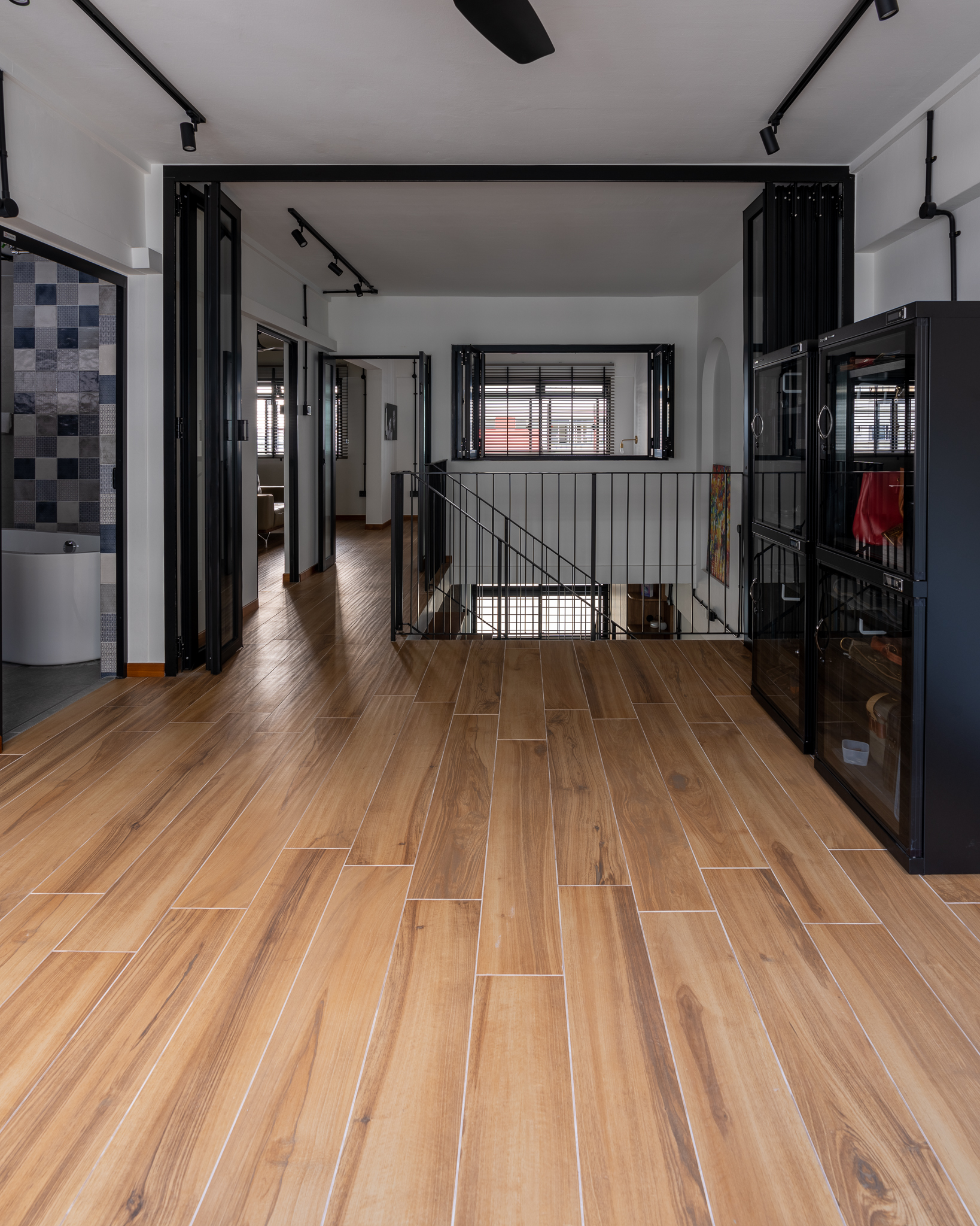 Breaking Walls and Perspectives - Modern bathroom interior, sleek black fixtures, wooden floor tiles, contemporary design