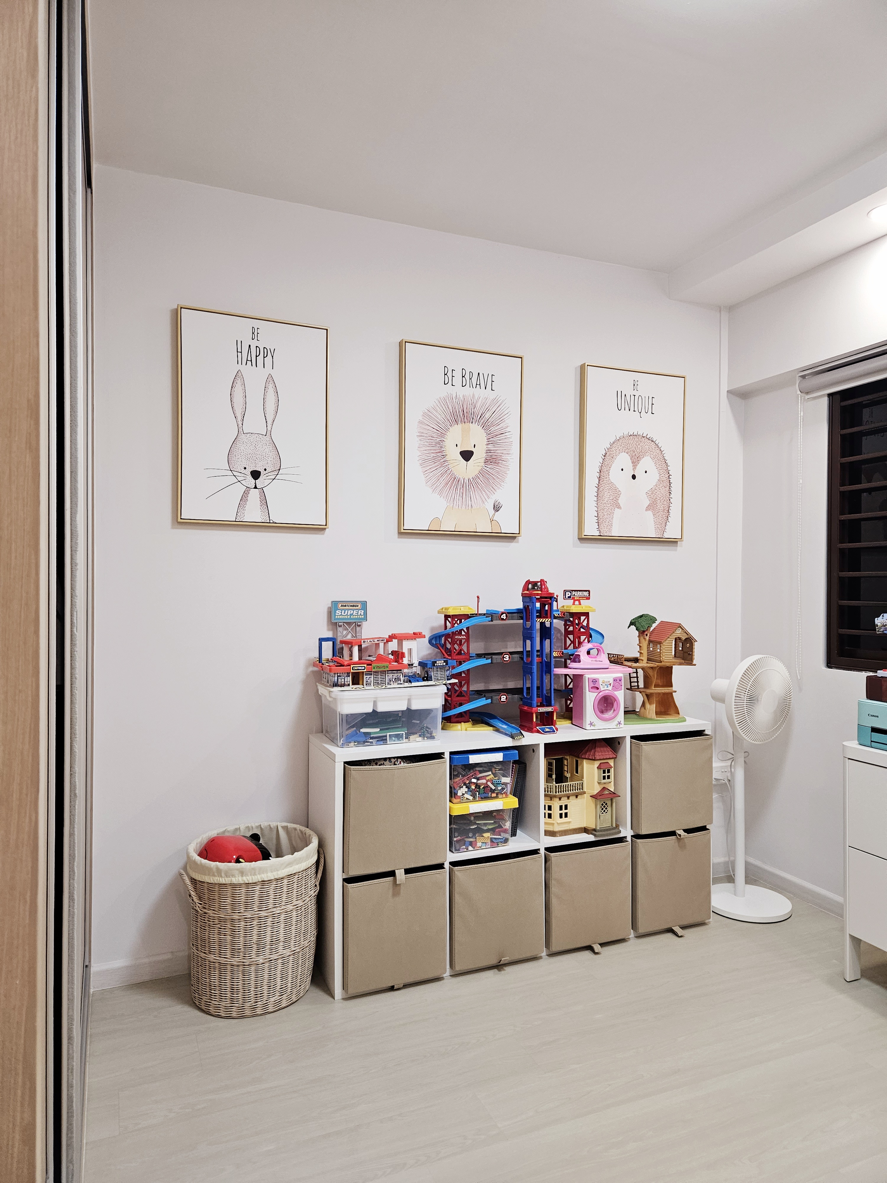 Kid's playroom! - Wall art featuring a rabbit, lion, and hedgehog, framed with inspirational quotes. Toy storage unit with