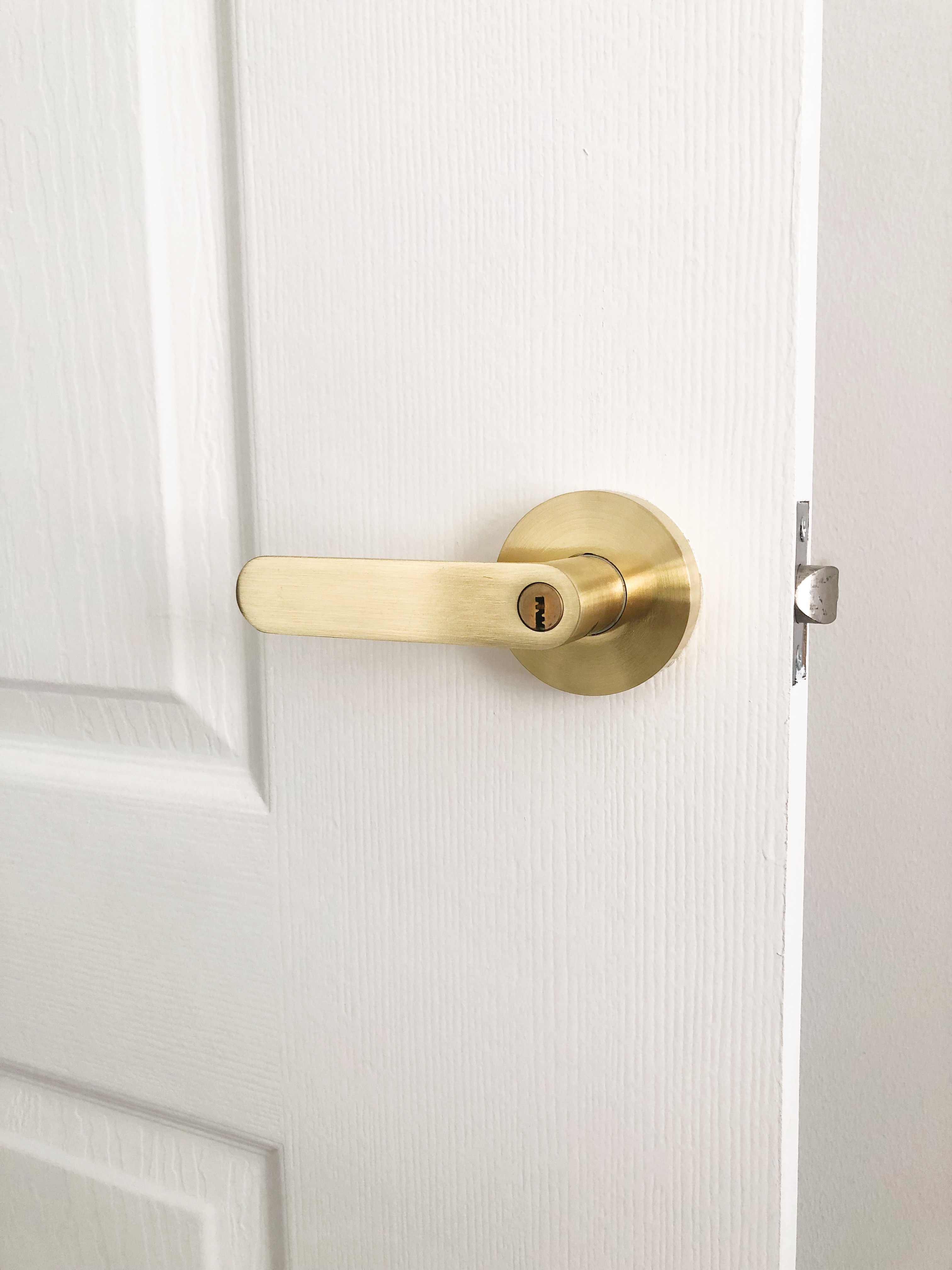 Customising Our BTO Room Doors - Gold door handle, brass door knob, white textured wall, minimalist design, elegant door