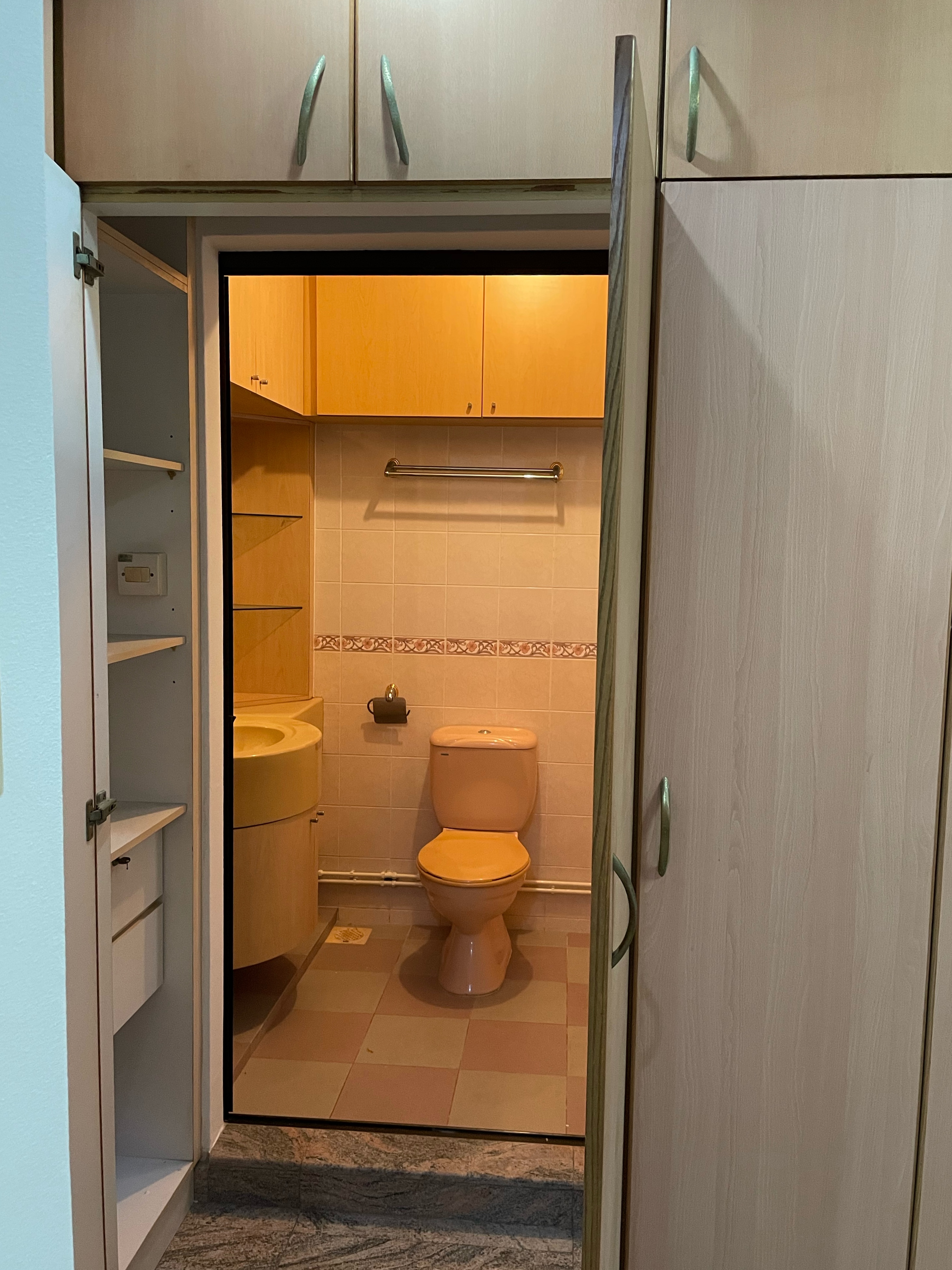 We Hacked Everything for This Bedroom Transformation - Wooden cabinet with metal handles, open doorway leading to bathroom