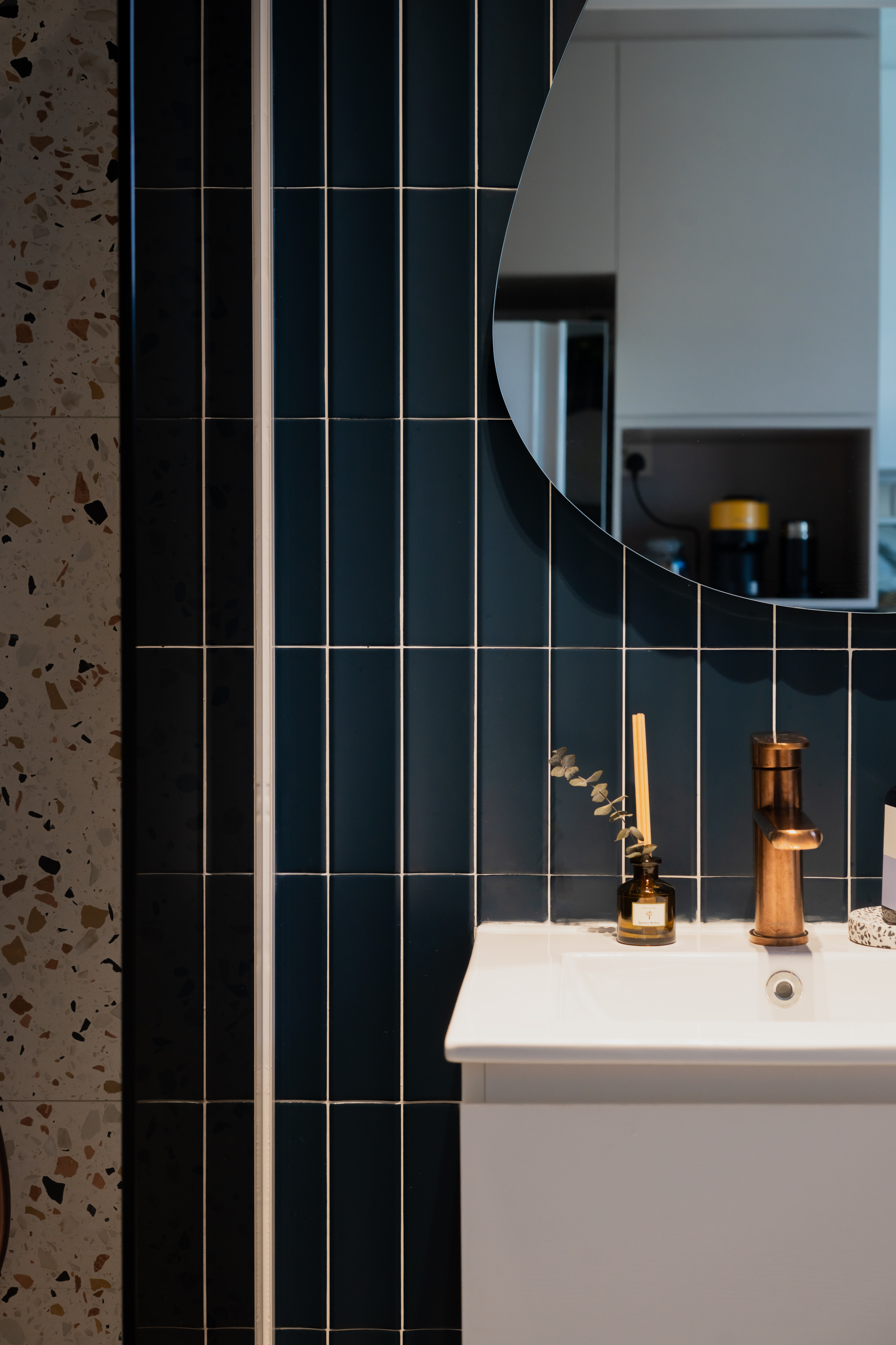 Italian cafe inspired theme  - Dark blue tiled wall, white countertop, modern faucet, copper faucet handle, small vase with