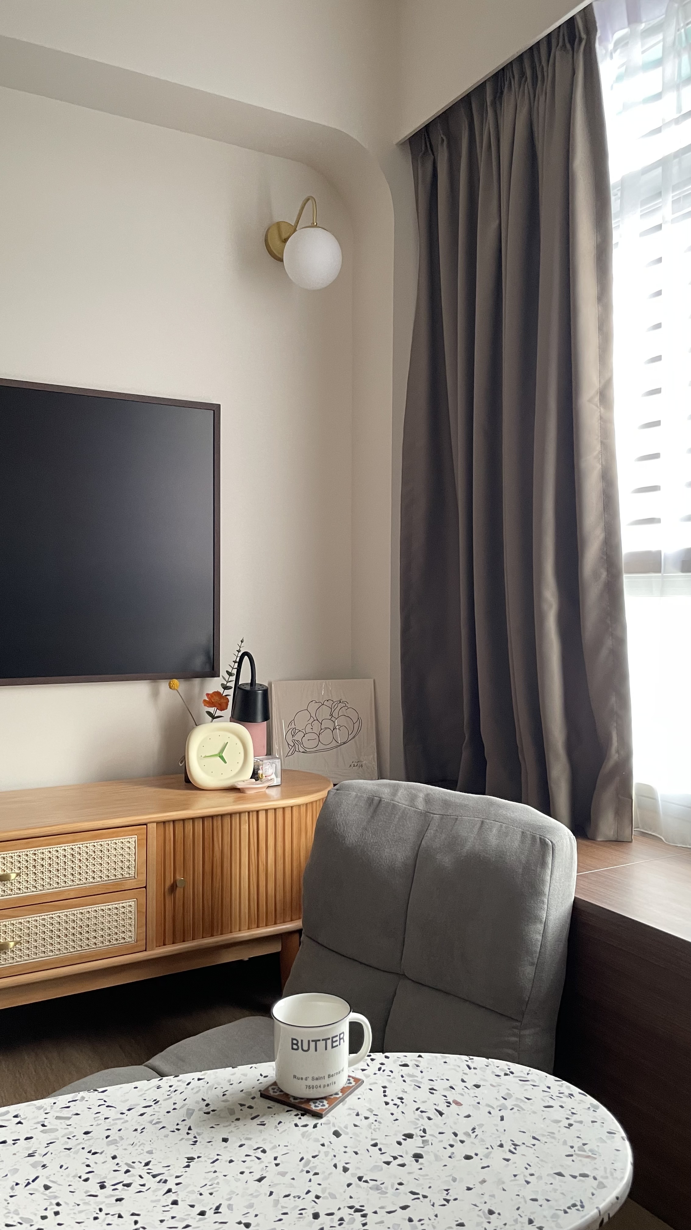 Cosy Corner where the cat lies 🐱  - Wooden TV cabinet, gray armchair, black TV, white clock, pink lantern, abstract artwork