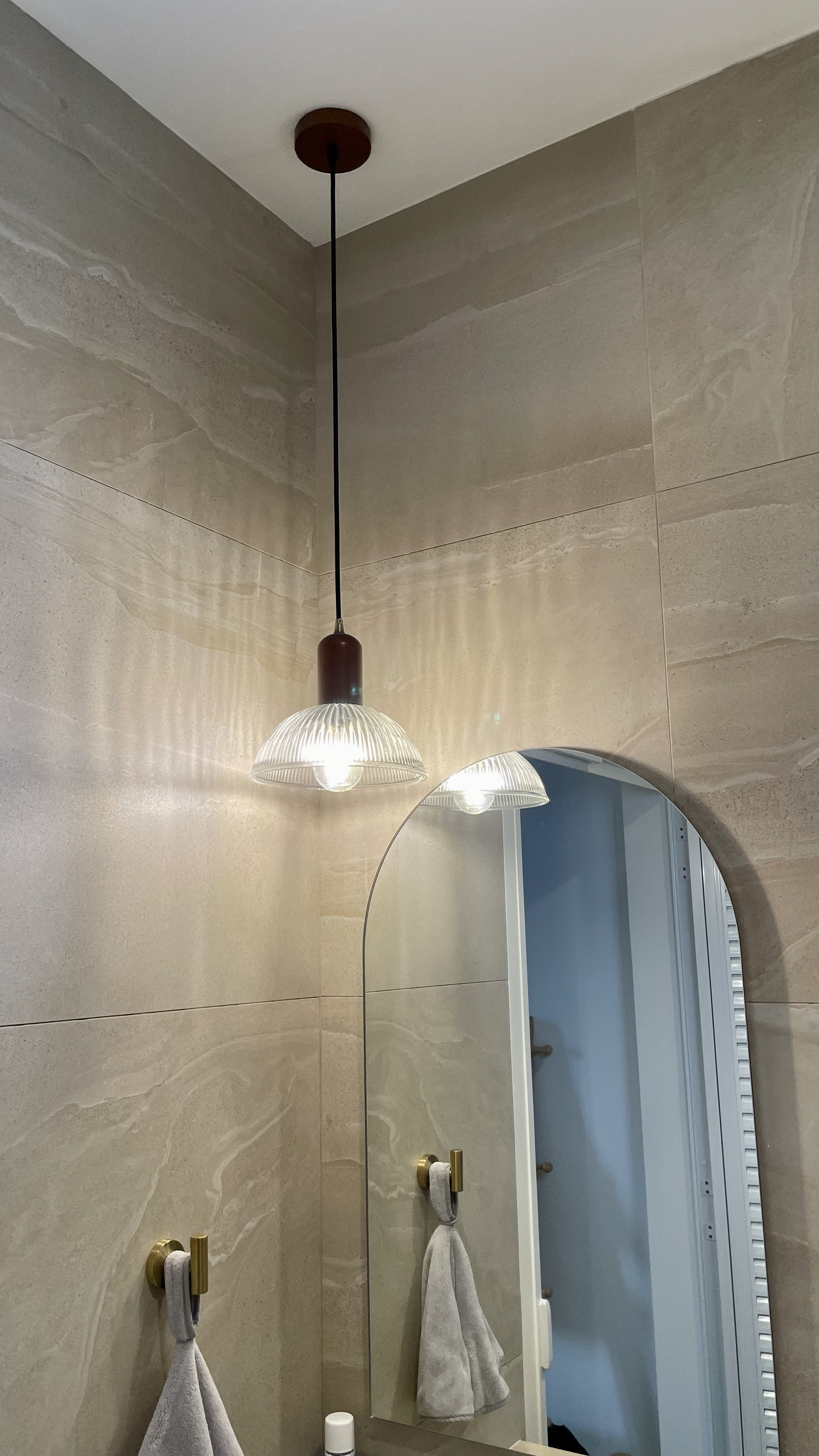 Travertine Hotel Bathroom in BTO - modern bathroom, stylish design, beige tiles, arched mirror, pendant lights, minimalist