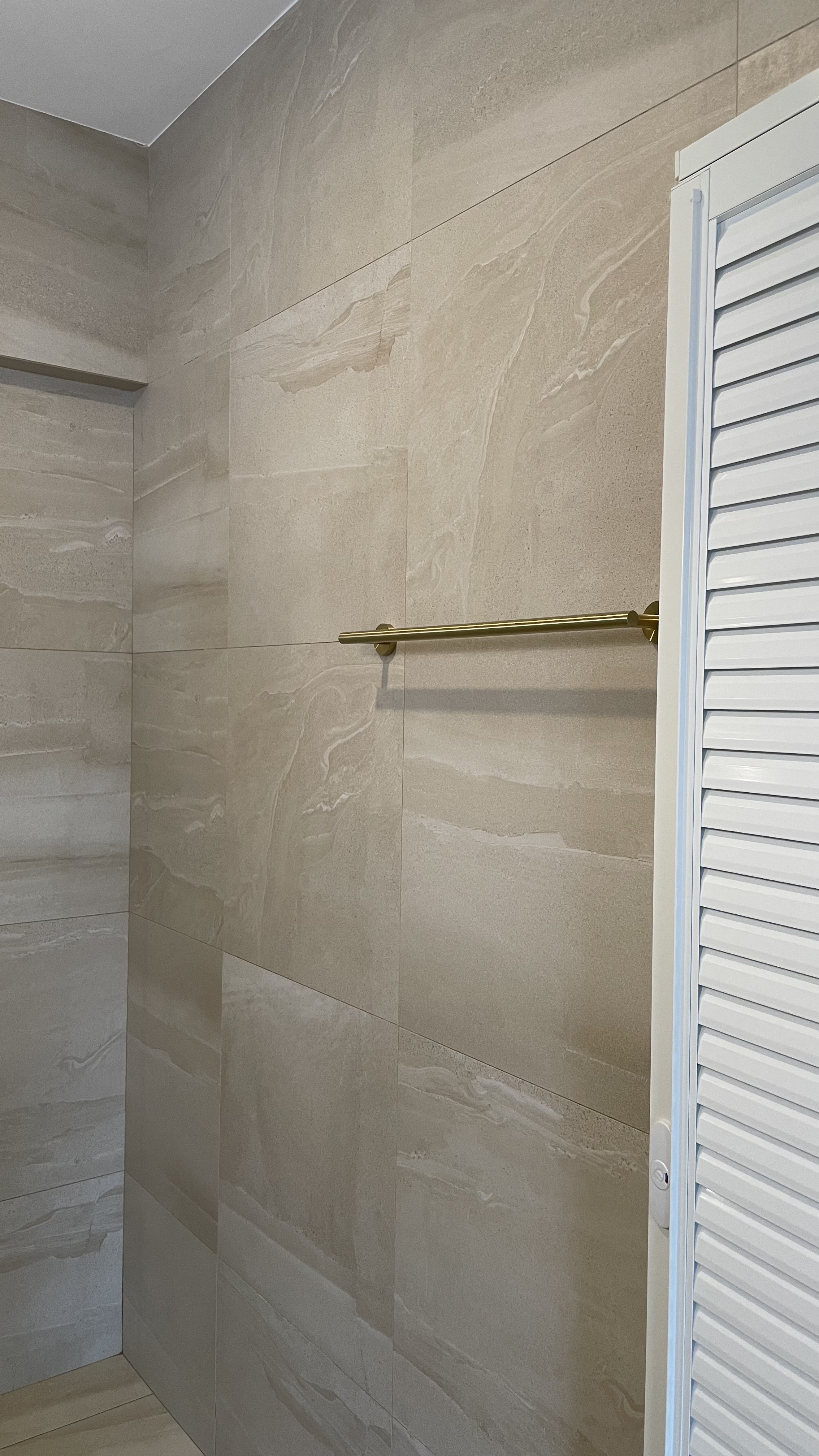 Travertine Hotel Bathroom in BTO - Modern bathroom, beige marble tiles, sleek design, minimalist decor, contemporary style