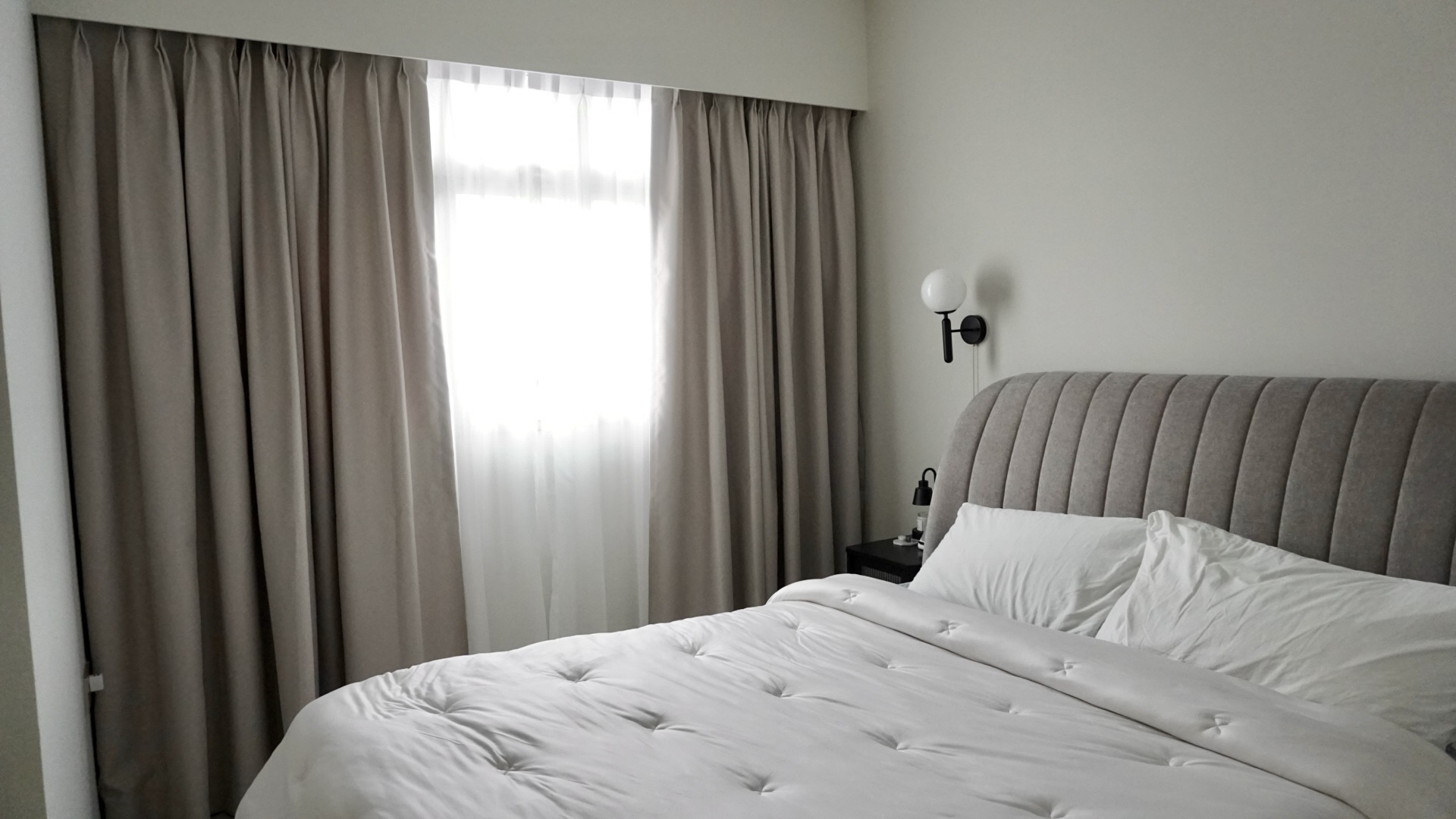 Creating our abode on cloud9, without an ID.  - Cream-colored, tufted headboard, white comforter, beige curtains, soft