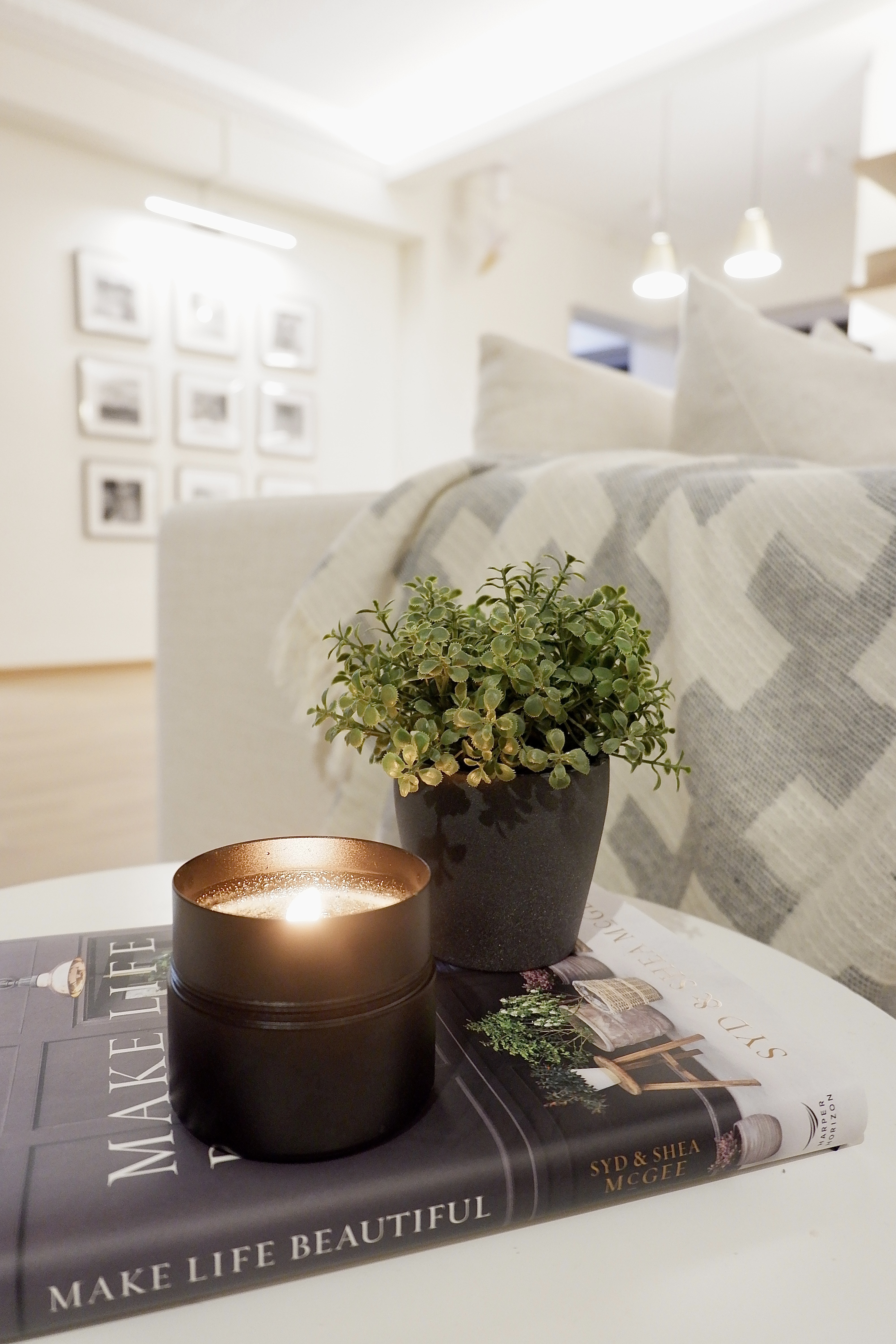 Designing our own modern farmhouse. - Candle, indoor setting, cozy atmosphere, modern decor, soft lighting, book, "Make Life